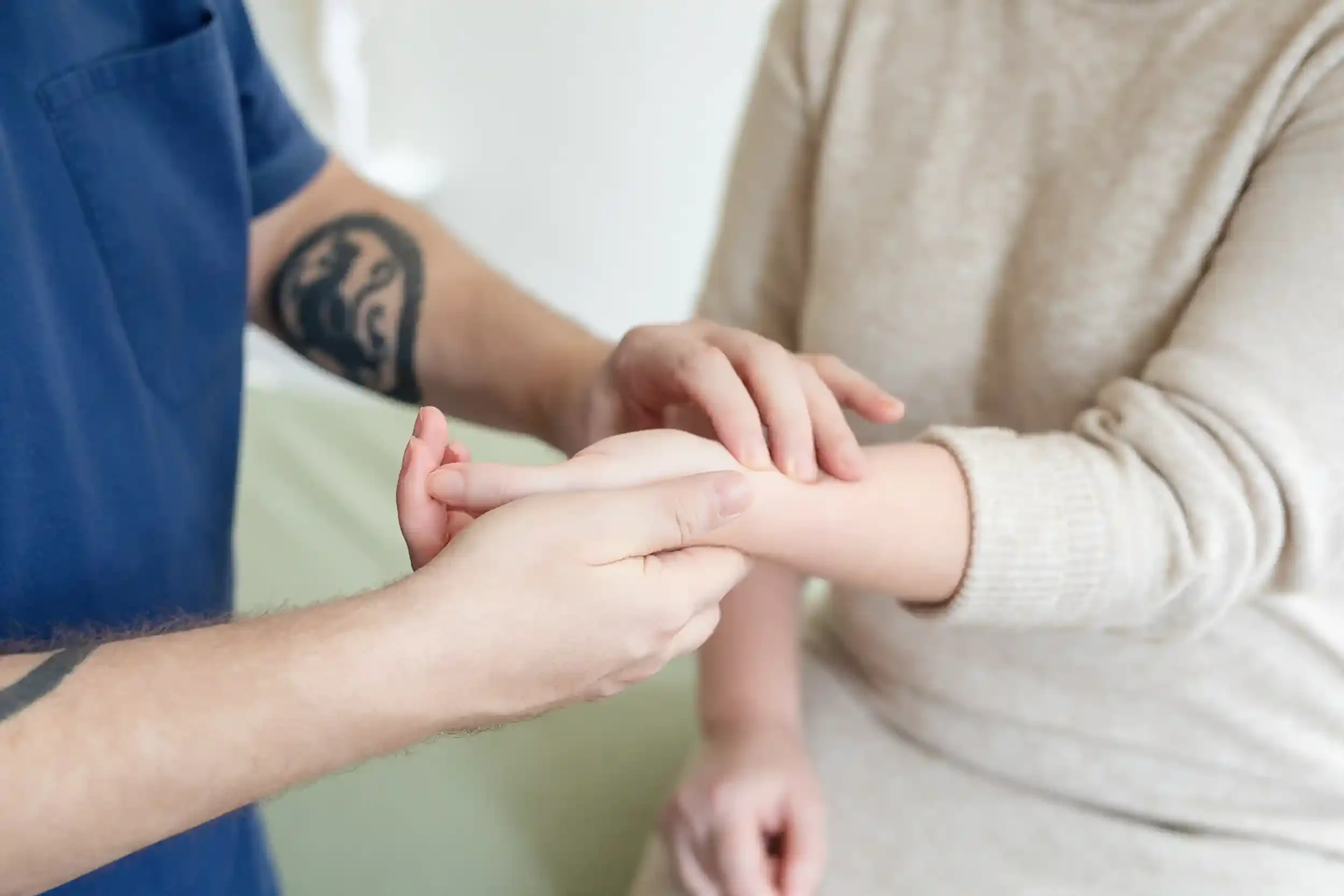 Acupuncturist assessing patient health through pulse diagnosis.