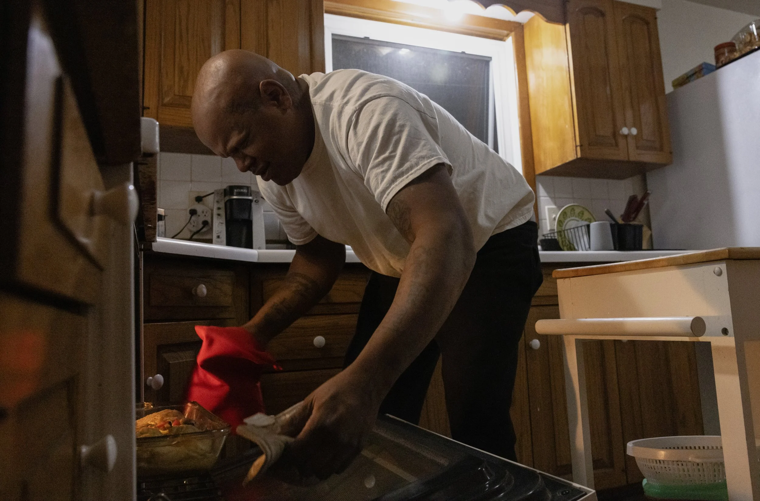 Bobby pulls out freshly-baked chicken for his birthday dinner at the Daisy House. Bobby was originally going to grill them outside until he stepped in dog poop and quickly moved plans indoors. He, however, doesn't seem to mind much. "I'm just gratefu