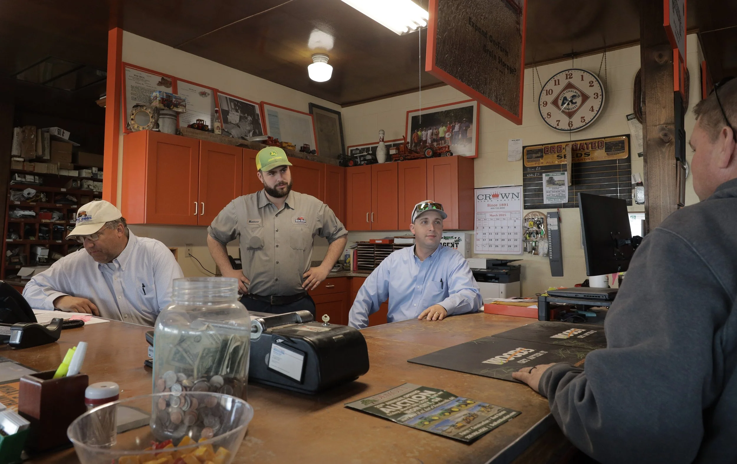 From left: David, Matthew and Harrison Backer help customer John Bryant on March 20, 2025, in Kingdom City, Mo. Wise Bros. Inc. is on its fifth generation of owners, with Matthew and Harrison running the daily operations of the store, while David spl