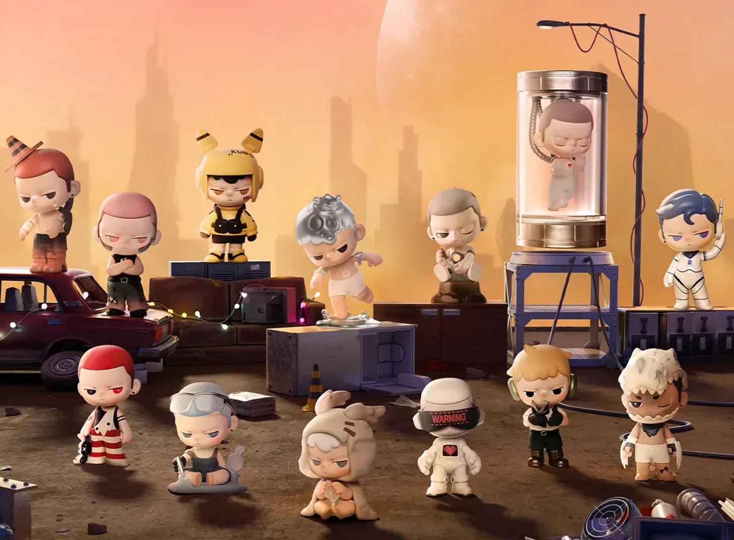 A staged “PRODUCT SHOW” diorama with multiple KUBO figures posed on crates and a dusty ground under an orange sunset sky; one figure appears inside a tall transparent capsule on a stand, with an old car and city silhouettes in the background.