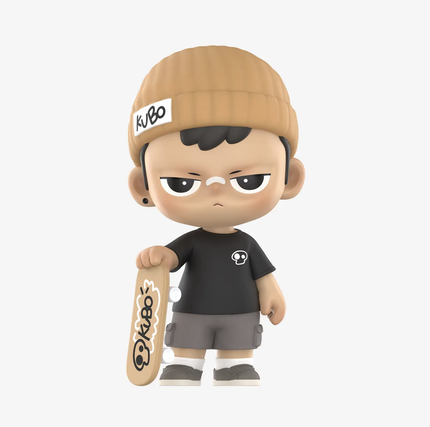 Studio product image of the KUBO “Speeding Along” figure wearing a tan beanie labeled “KUBO,” a black T-shirt, gray shorts, and sneakers, holding a tan skateboard printed with the KUBO logo.