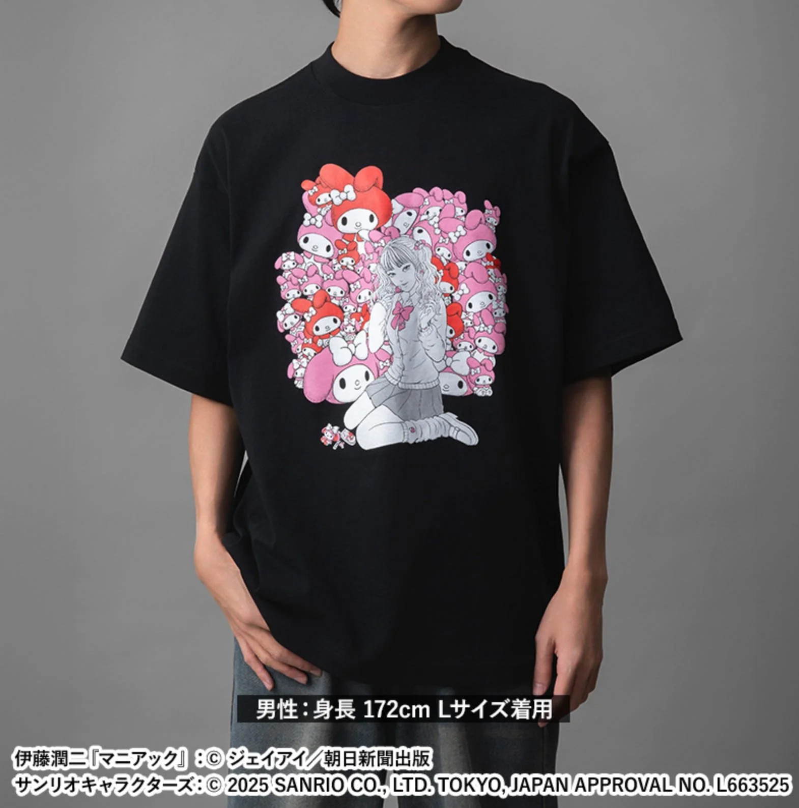 Model wearing a black T-shirt with Tomie artwork over a pink/red My Melody-pattern background.
