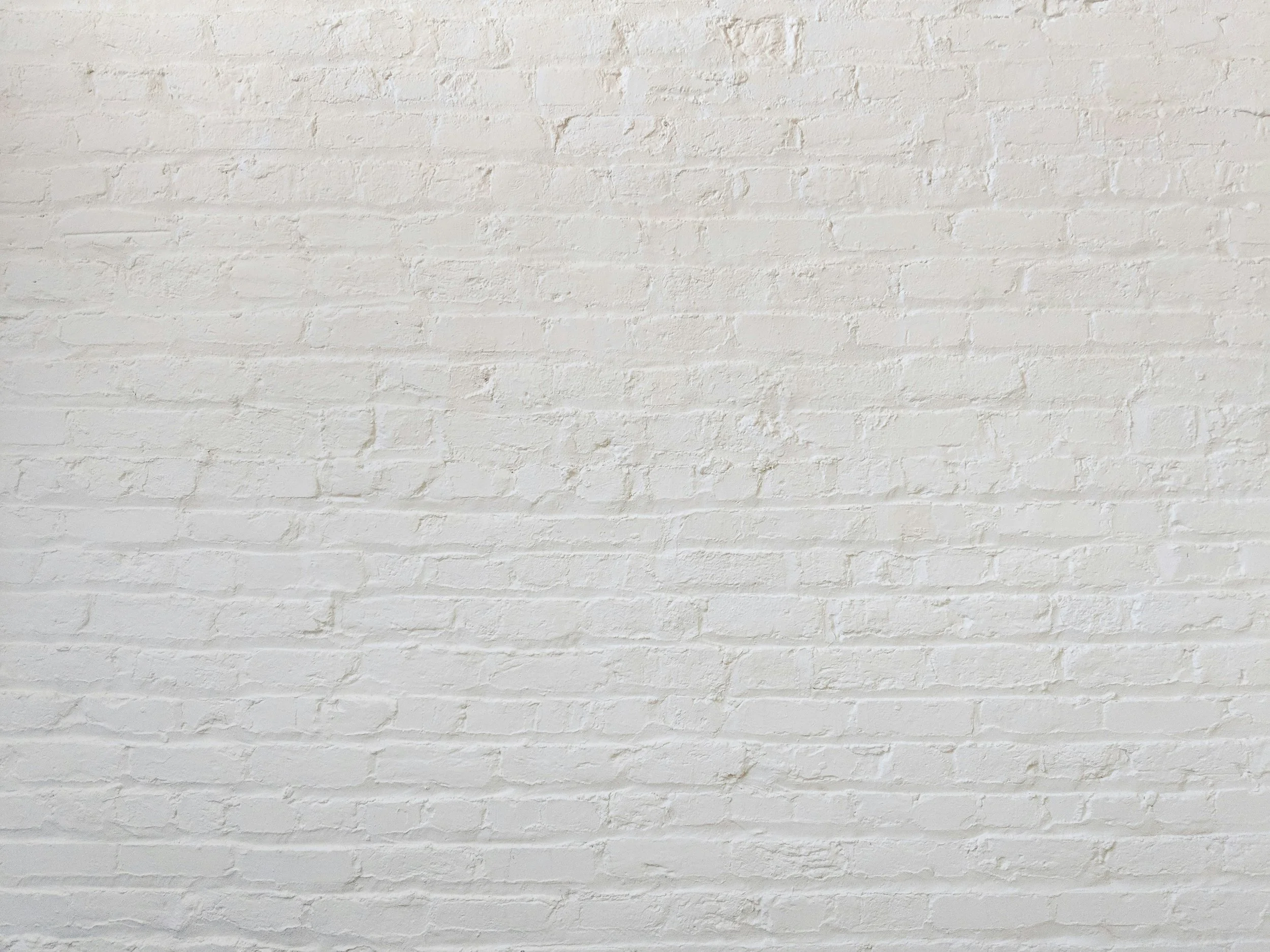 White painted brick wall.