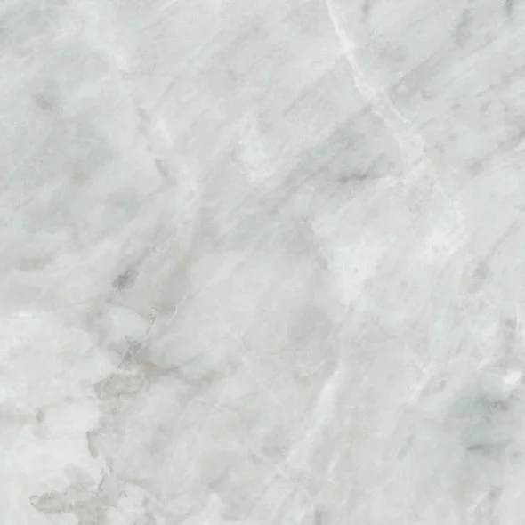 Close-up of a white marble surface with gray veining.