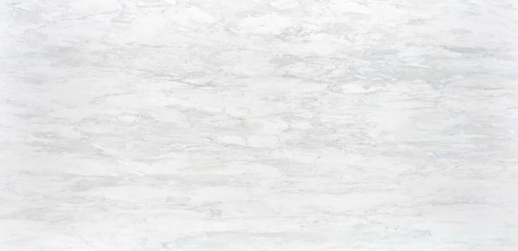 Whitewashed wooden surface with a weathered texture.