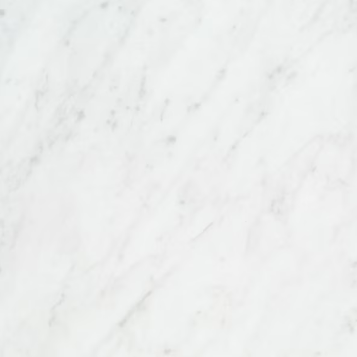 Close-up of a white marble surface with subtle gray veining.