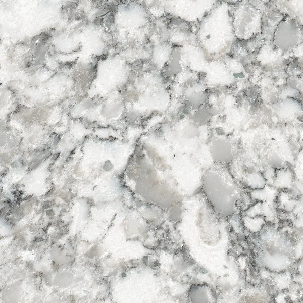 Close-up of a snowy surface with footprints and ice patches.