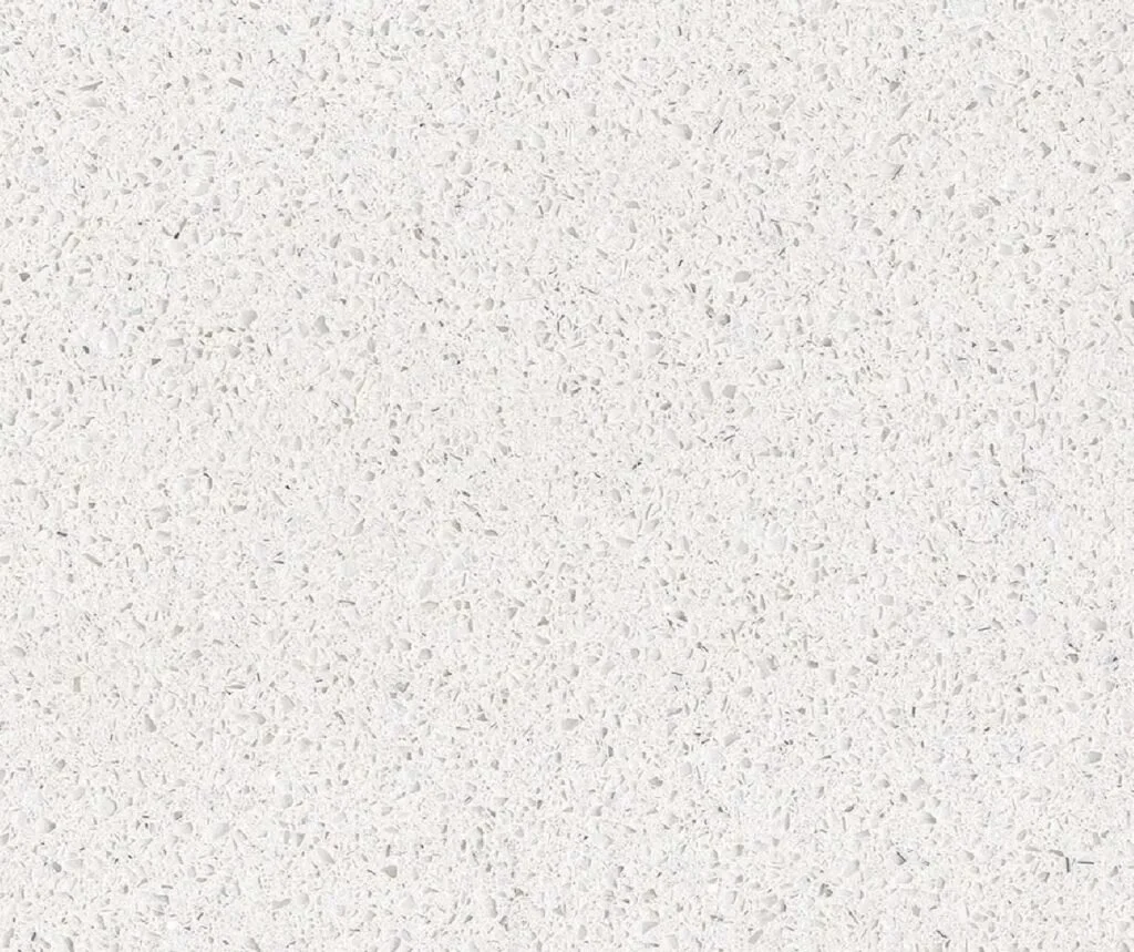 Close-up of a white paper with faint speckles and a tiny hole.