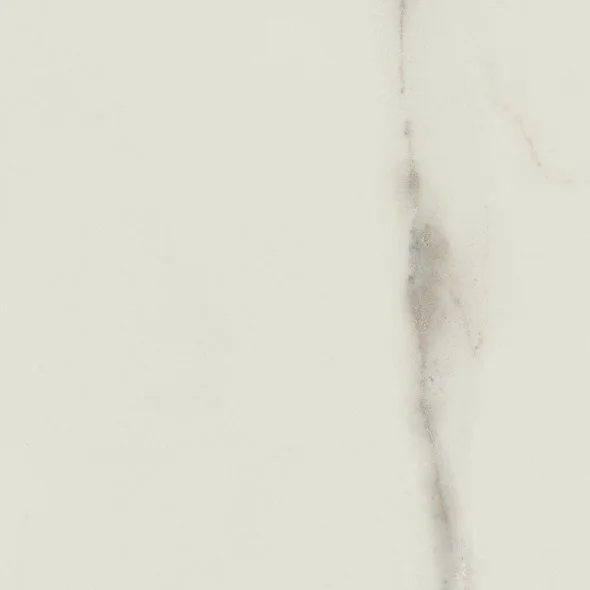 Close-up of a white wall with a rust stain and small cracks.