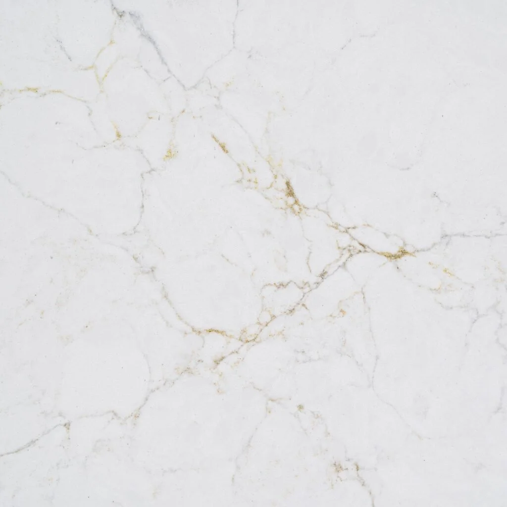 Close-up of a white marble surface with light brown and gold veining.