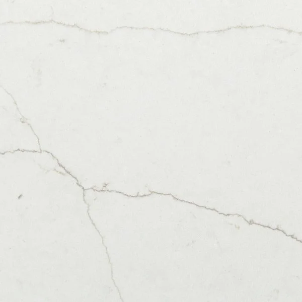Close-up of a white marble surface with subtle gray veining.