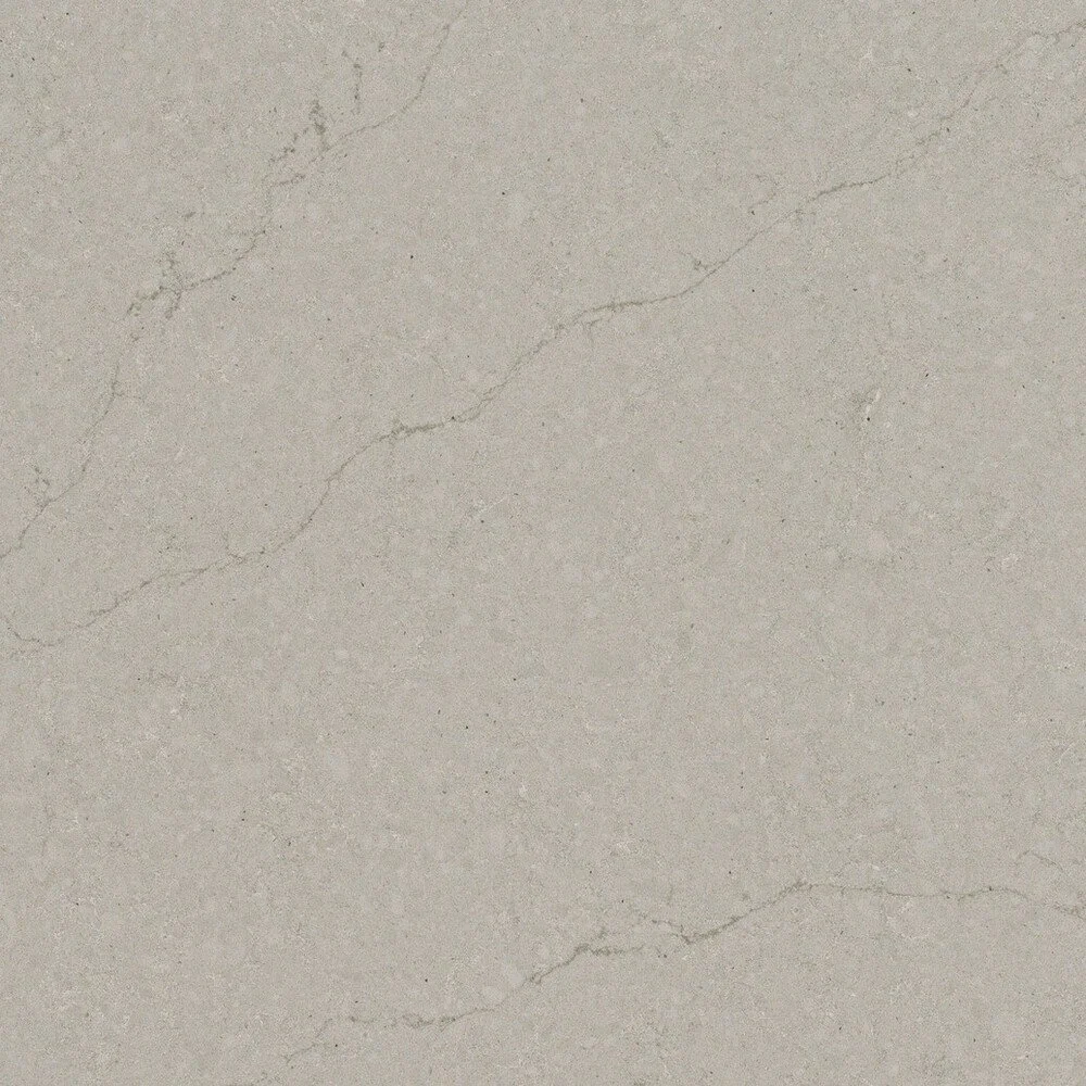 Close-up of a beige marble surface with natural veins and cracks.