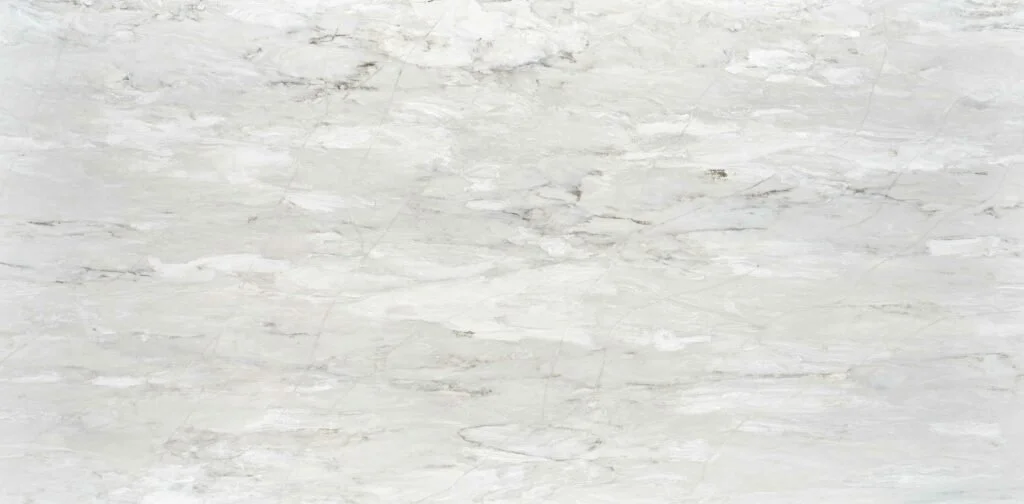 A light-colored marble surface with subtle gray and beige veining.