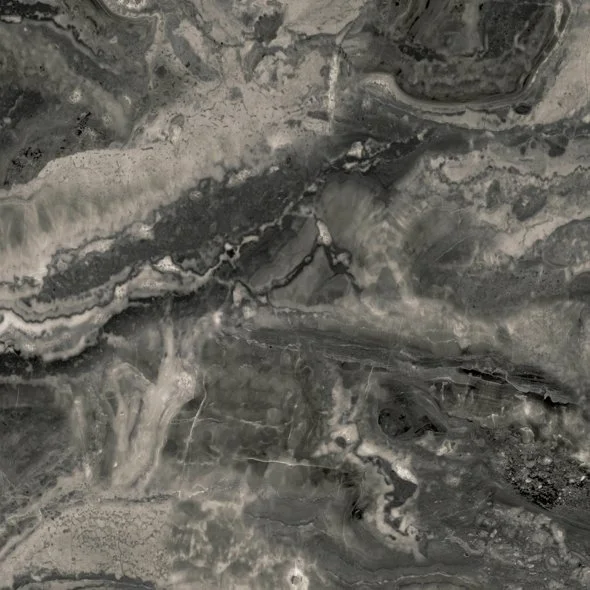 Close-up of a gray and black marble surface with natural veining and patterns.