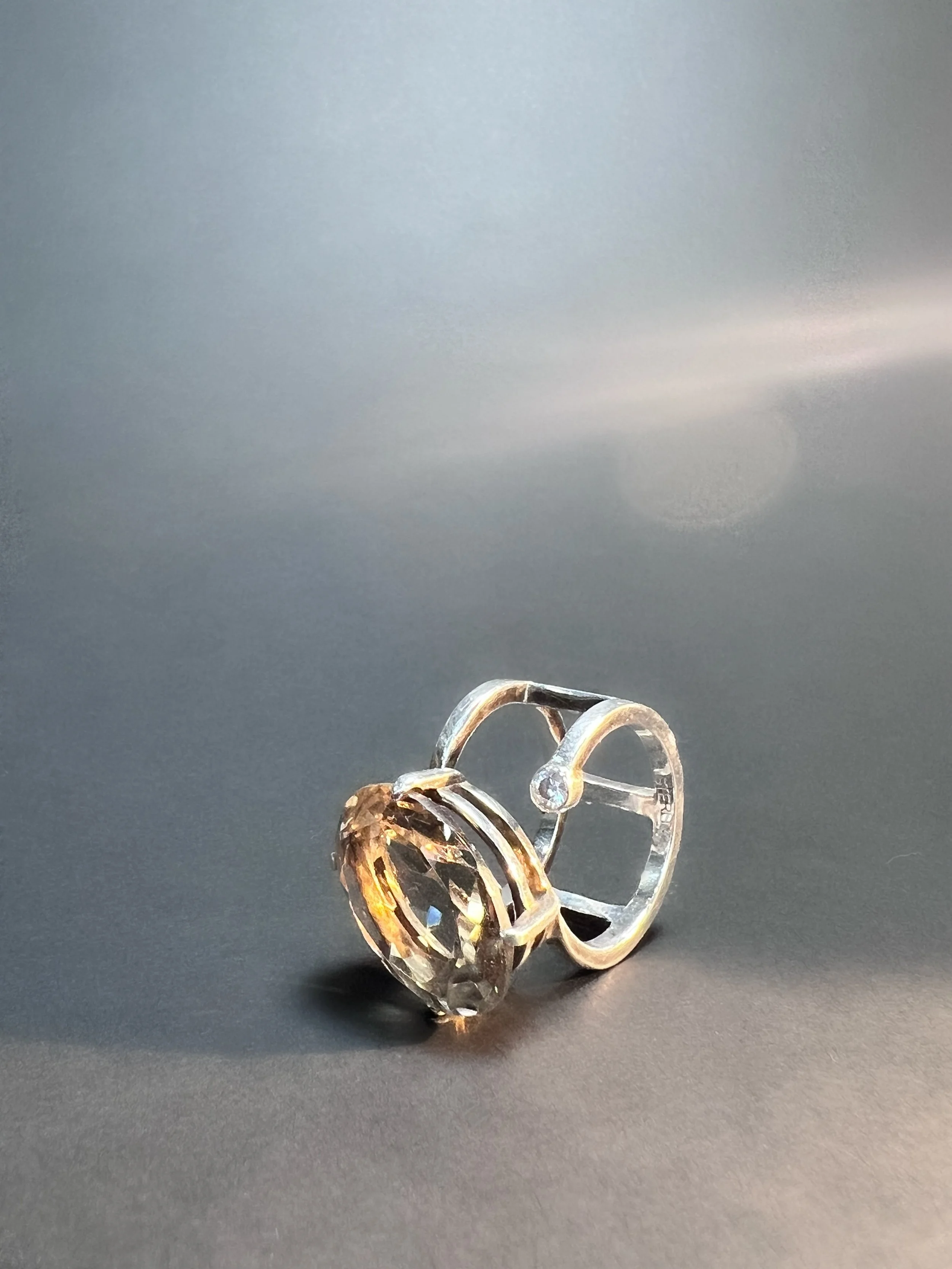 Close-up photo of three gold rings, with a black background.