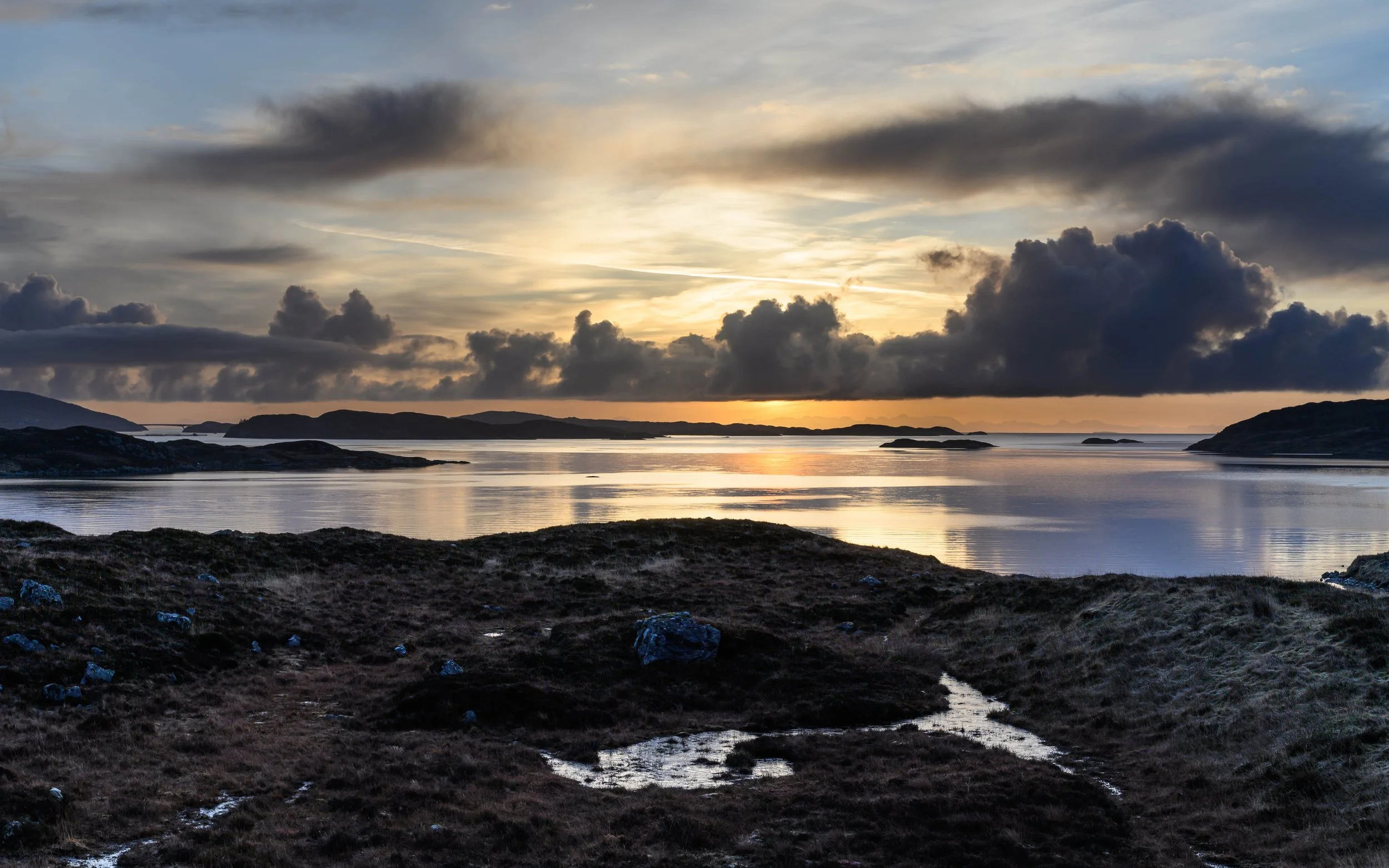 Sunrise over Loch Ceann Dibig with the Isle of Skye on the horizon