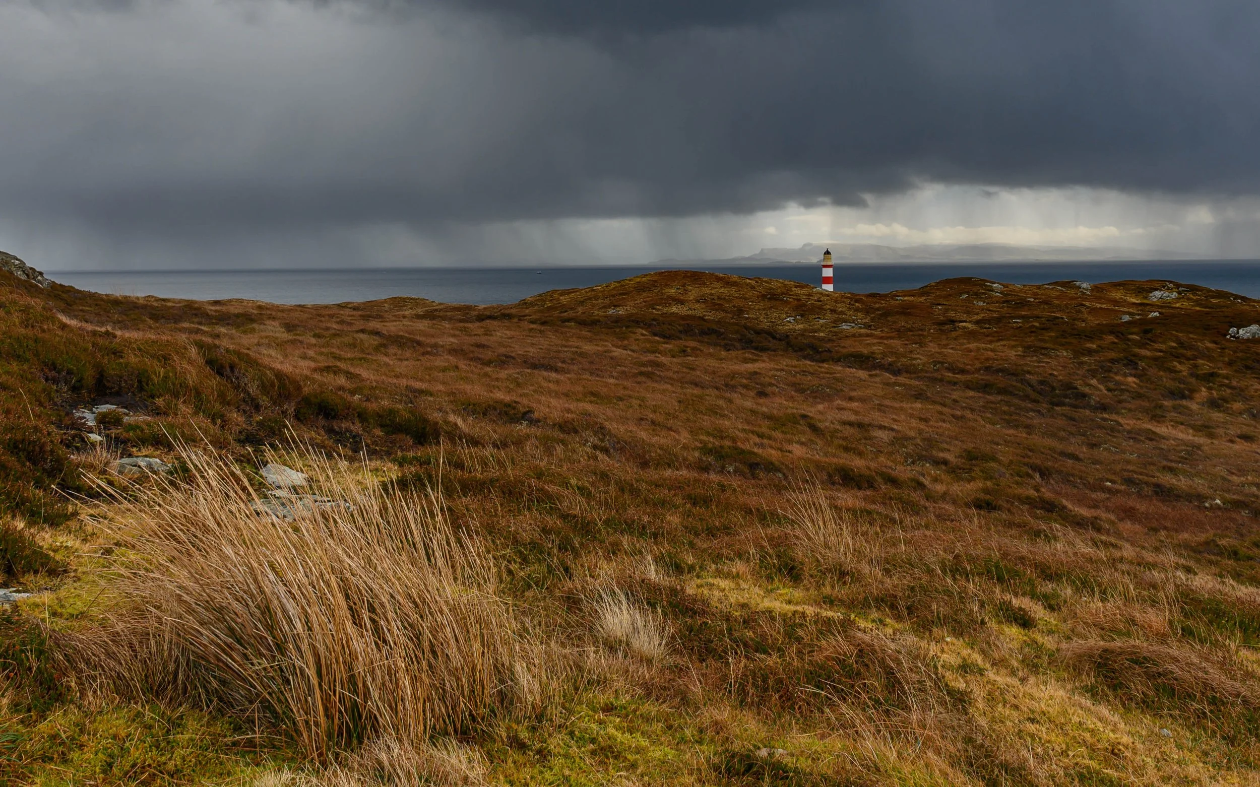 Eileen Glass lighthouse on Scalpay with Isle of Skye on the horizon