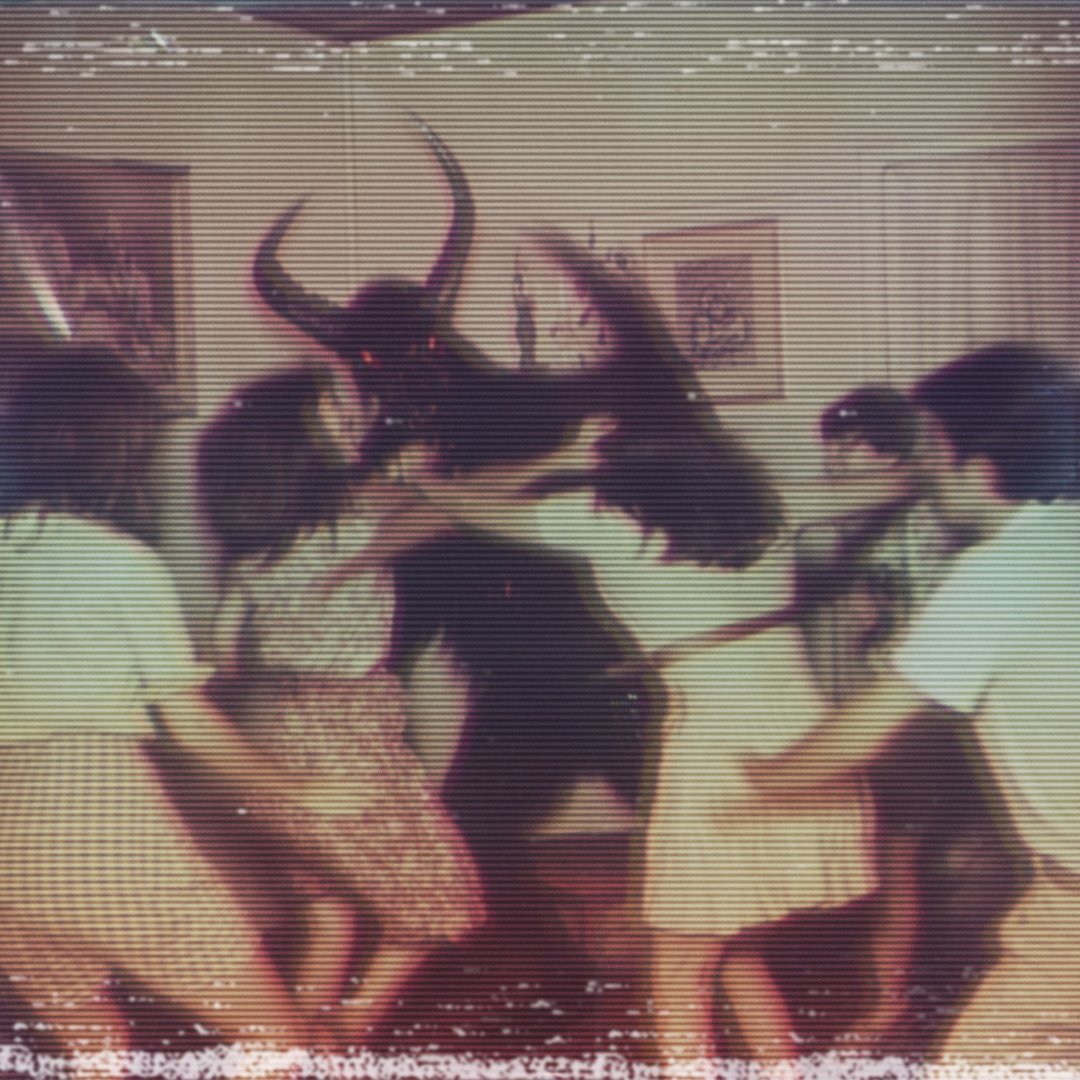 Vintage-style photo of children appearing to dance or play around a person in a horned costume with glowing eyes, creating a spooky, surreal scene.