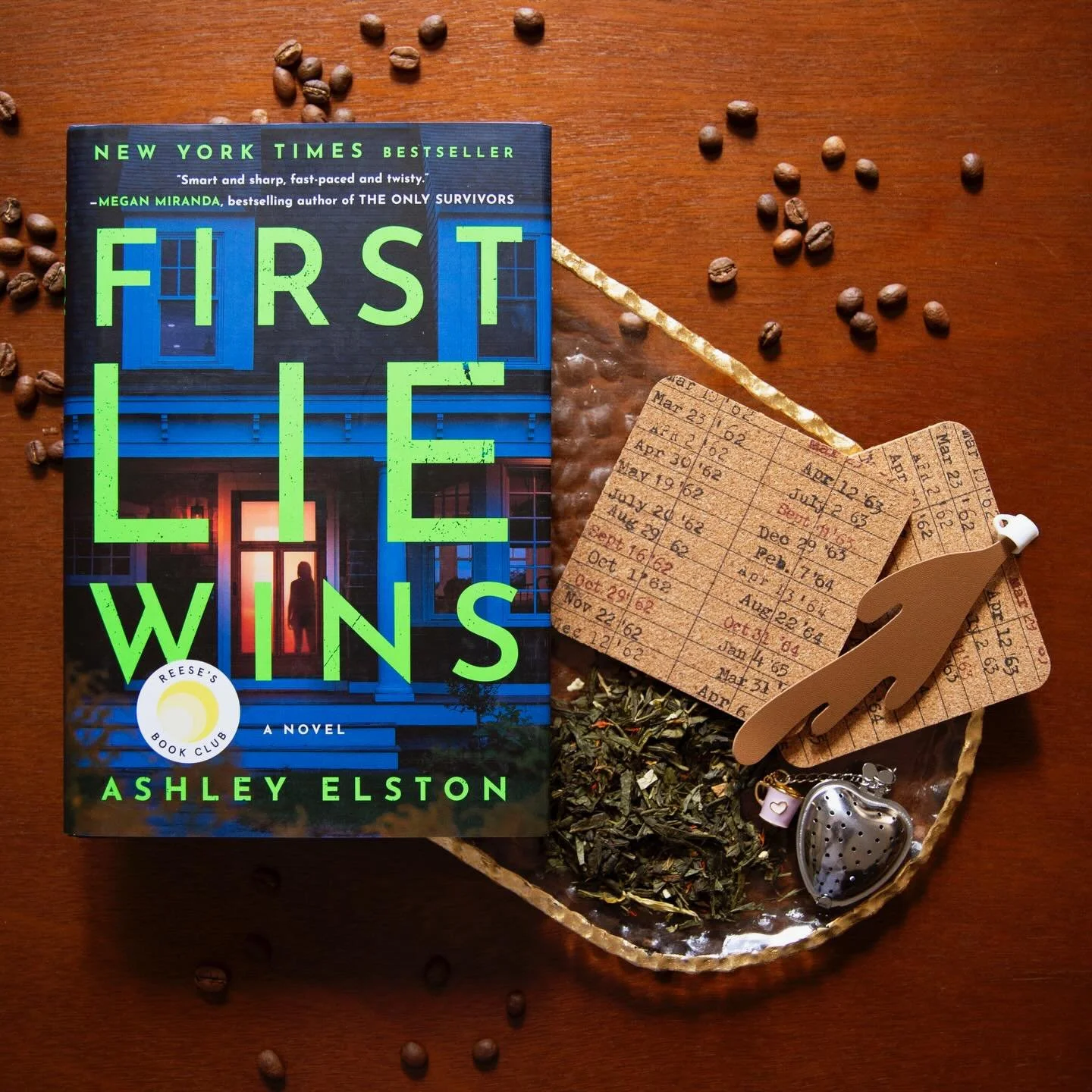 Be ready to sink into this mystery book with our April Bookmark box! 🔍✨

What you will find in your box:
🔍 Hardcover or Paperback copy of First Lie Wins by Ashley Elston
🔍Spilled coffee bookmark 
🔍Mug tea infuser
🔍library log coaster
🔍10g of gr