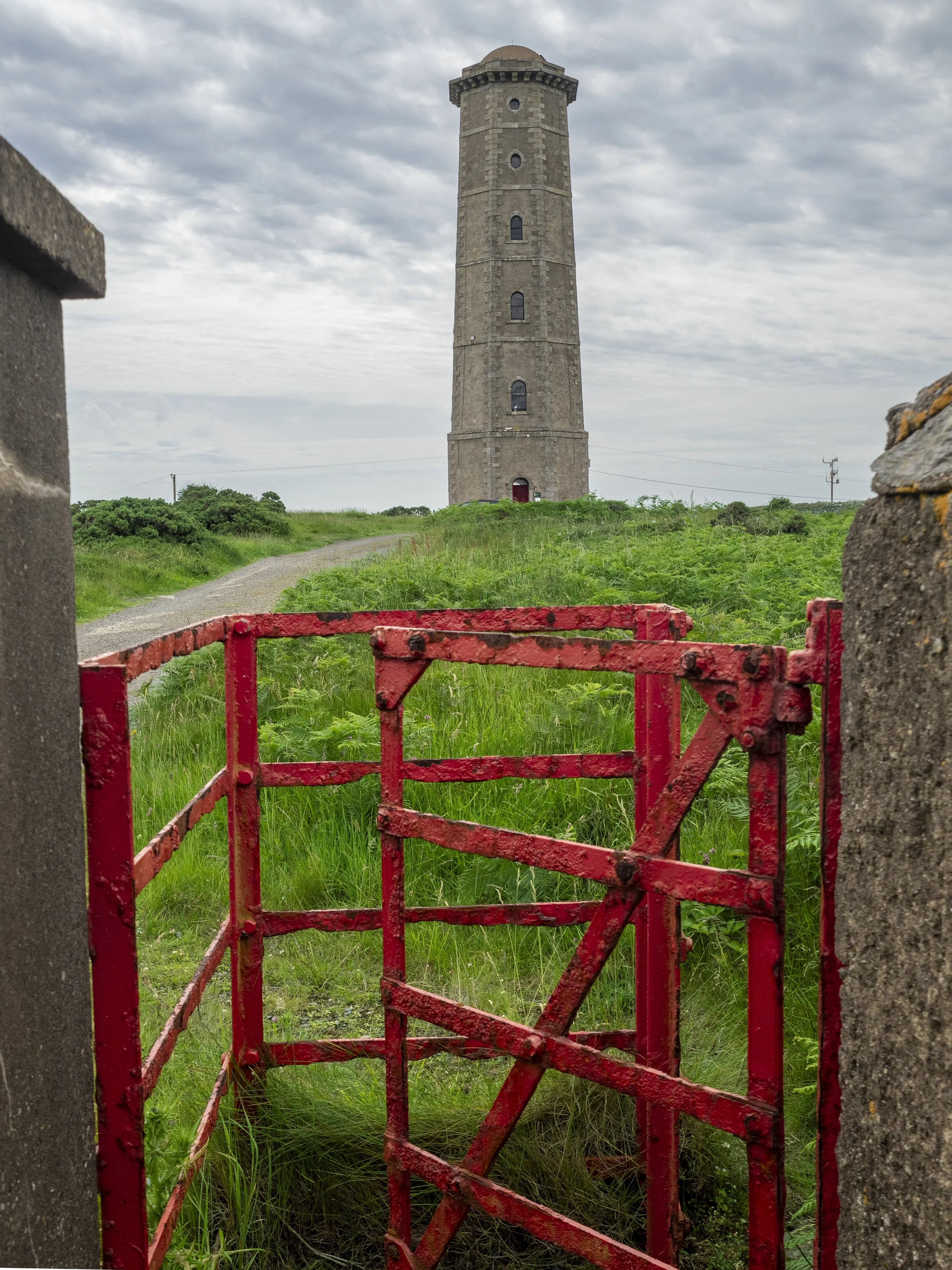 Wicklow Head Old Lighthouse and its red swing gate. July 26.