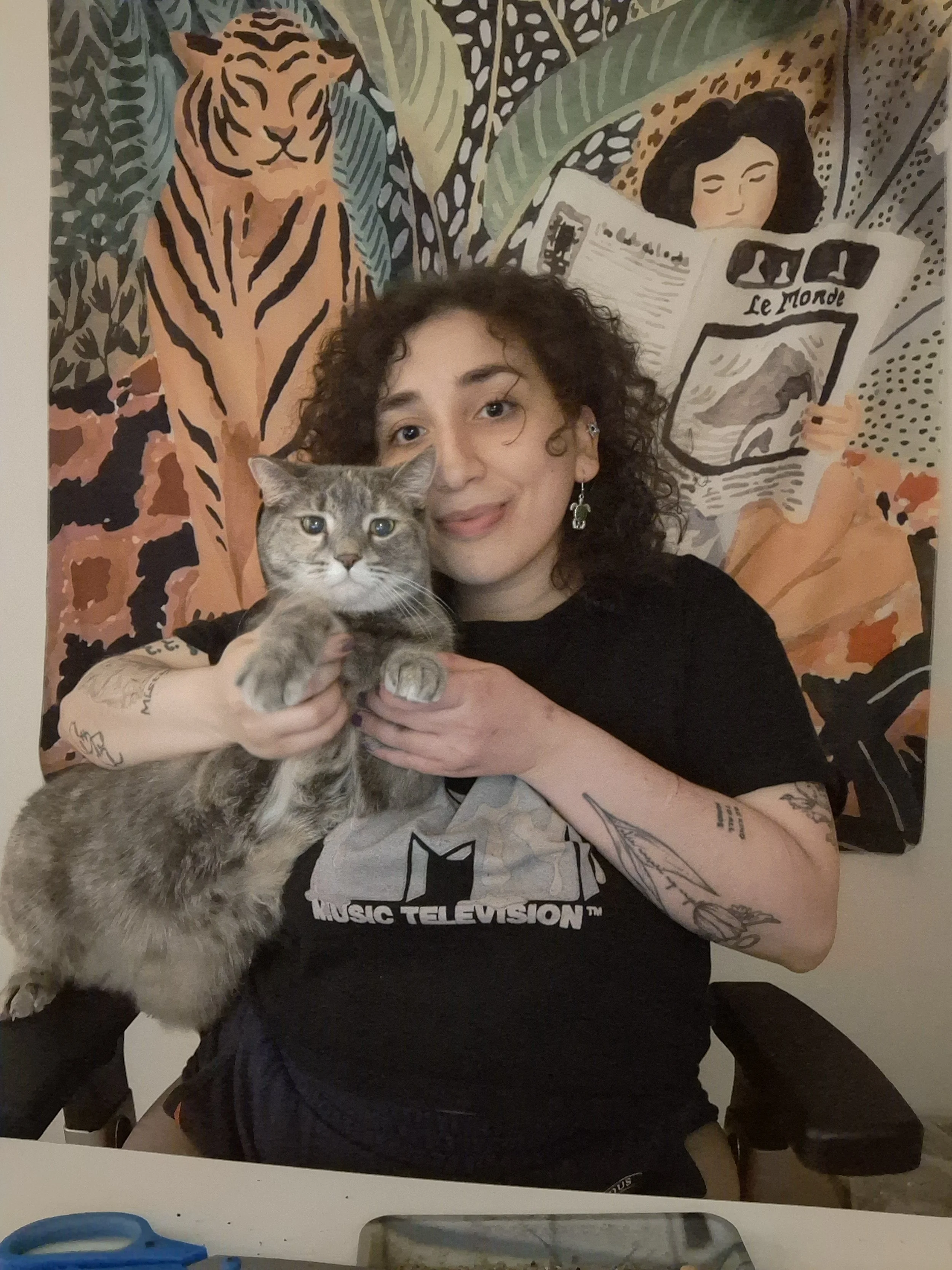 Children's author Aura Marsh holding her gray cat in an author portrait for Aura Marsh Books, creator of Goodnight Sheepy and the Dreamworld
