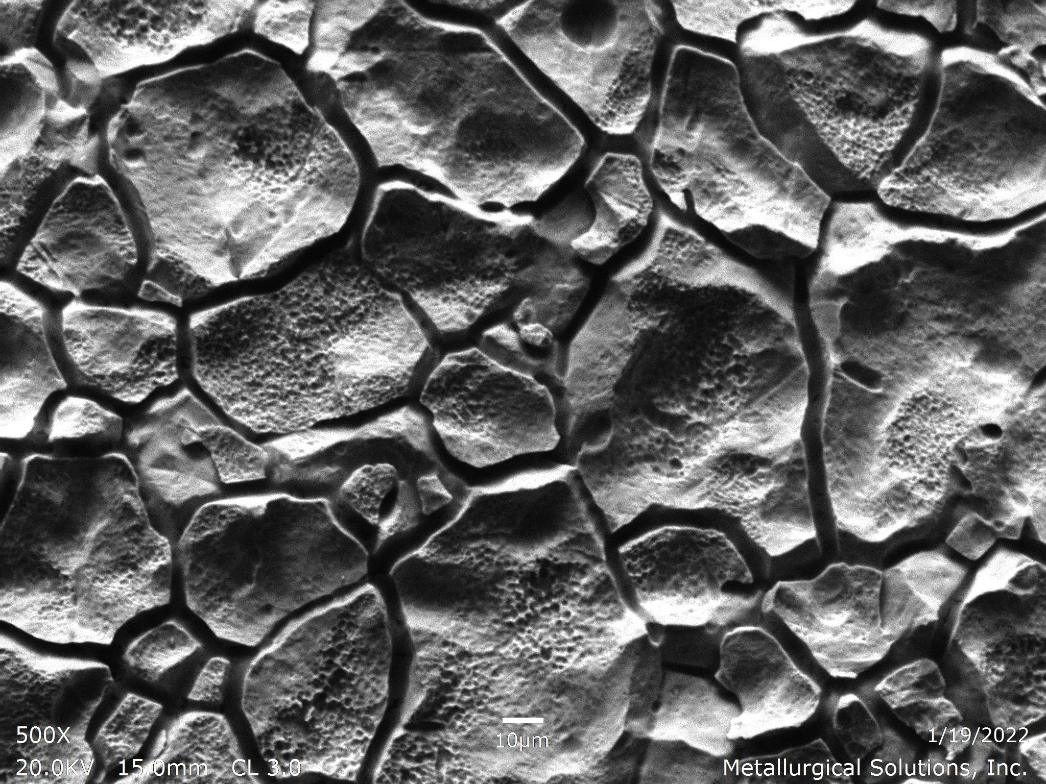 Intergranular corrosion on internal diameter surface SEI 500x, scanning electron microscope secondary electron imaging evaluation identifying severe intergranular corrosion IGC attack, deeply fissured grain boundary separation channels, and isolated 