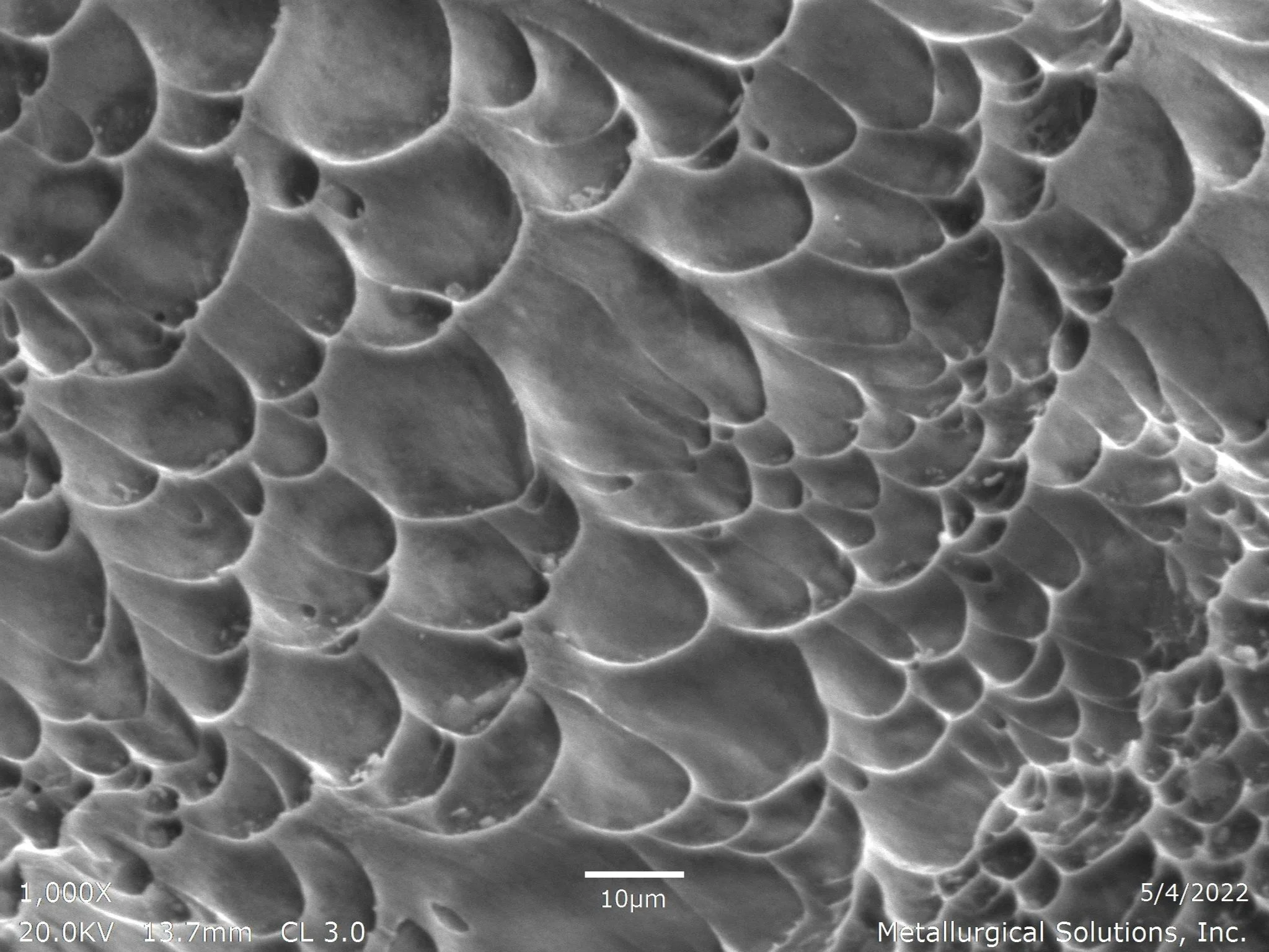 Shaft failure showing micro-void coalescence and ductile dimple morphology, scanning electron microscope SEM fractography evaluation identifying ductile overload rupture and tensile fracture propagation per ASTM E3 under ISO 17025 accredited laborato