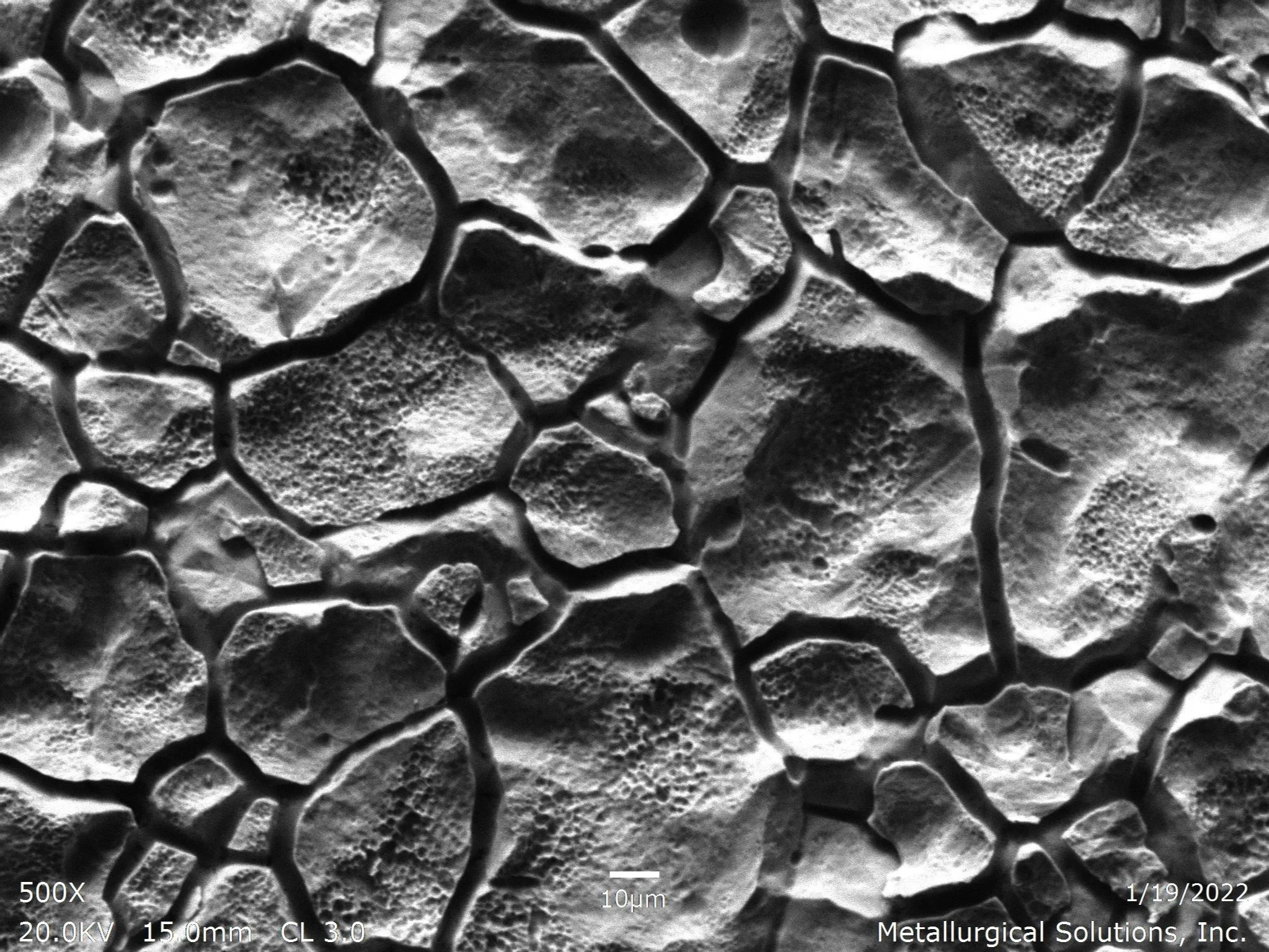 Intergranular corrosion on internal diameter surface SEI 500x, scanning electron microscope secondary electron imaging evaluation identifying severe intergranular corrosion IGC attack, deeply fissured grain boundary separation channels, and isolated 