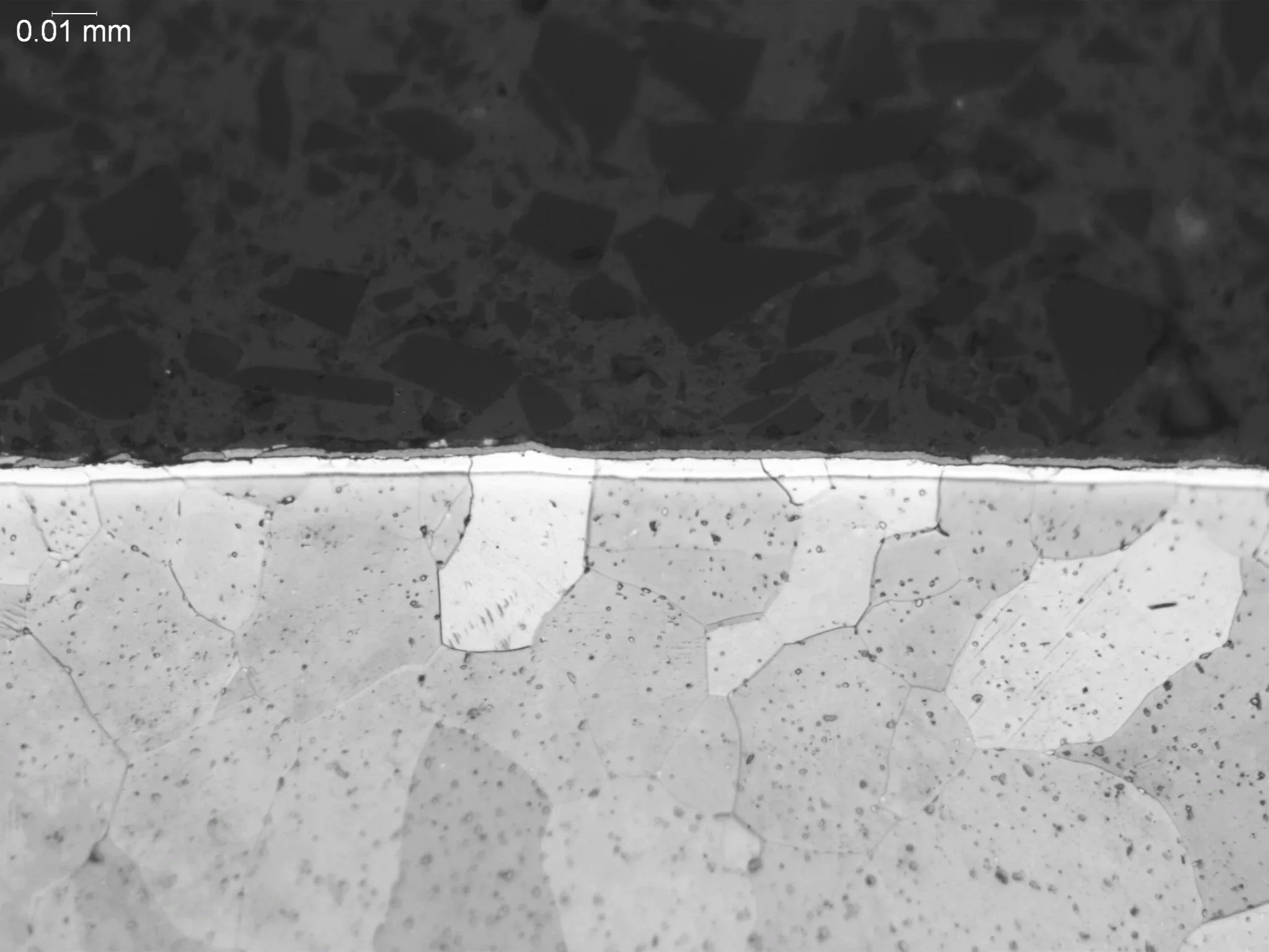 Alpha case on a titanium alloy structure, metallographic cross-sectional evaluation measuring oxygen-rich alpha case depth penetration, brittle alpha stabilized surface layer morphology, and grain boundary structures per GE S-400 quality specificatio