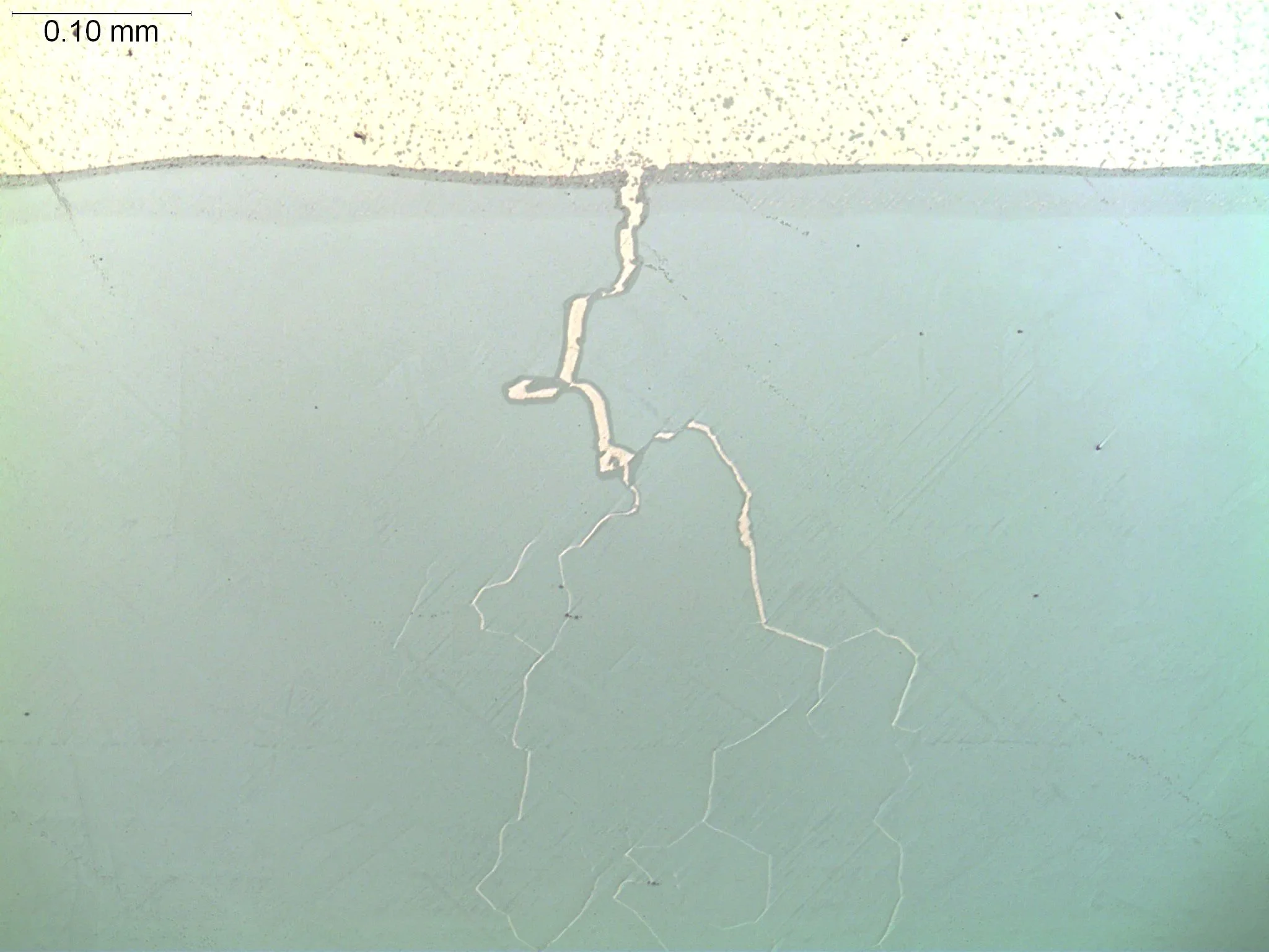 Liquid metal embrittlement (LME) crack branch, metallographic cross-sectional evaluation identifying branched intergranular fracture paths, molten filler metal penetration network, and alloy grain boundary cracking propagation per ASTM E3 under ISO 1