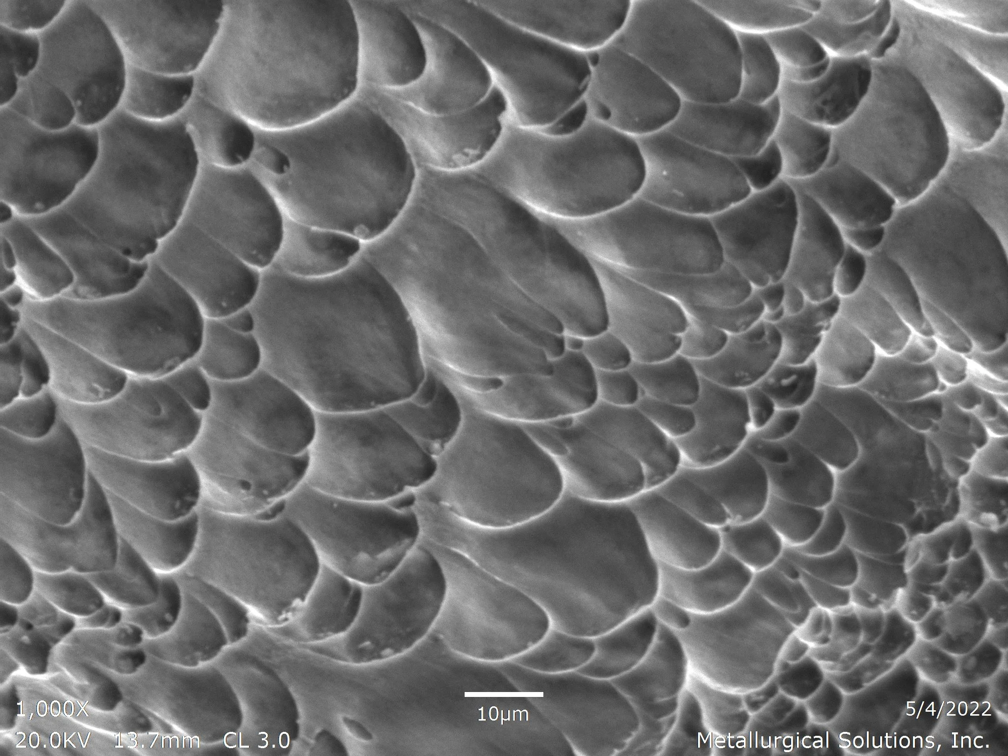 Shaft failure showing micro-void coalescence and ductile dimple morphology, scanning electron microscope SEM fractography evaluation identifying ductile overload rupture and tensile fracture propagation per ASTM E3 under ISO 17025 accredited laborato