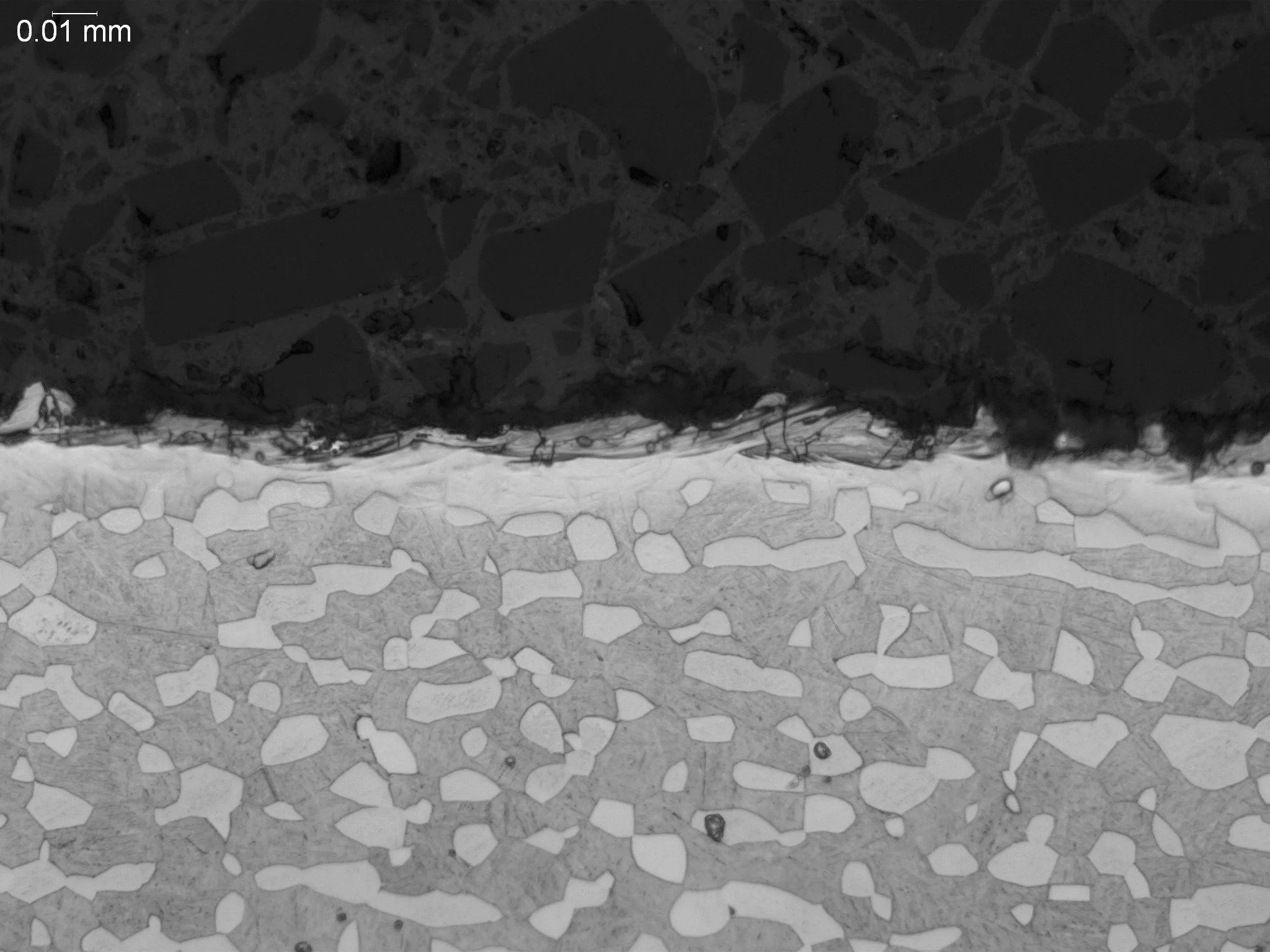 Recast layer from electrical discharge machining (EDM) on a titanium alloy, metallographic cross-sectional evaluation identifying a continuous micro-recast layer, shallow white layer depth profile, and an etched duplex alpha-beta titanium base micros