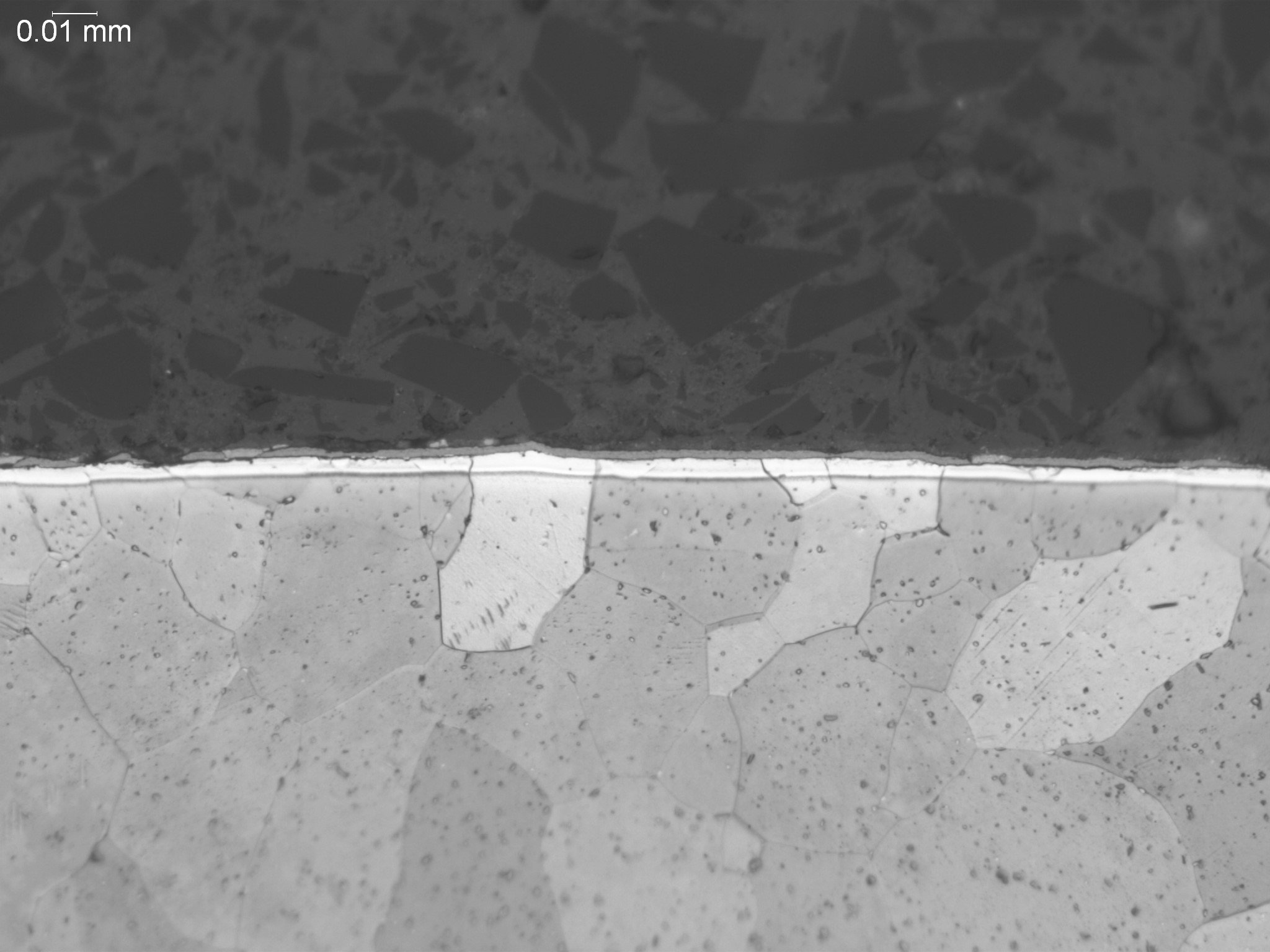 Alpha case on a titanium alloy structure, metallographic cross-sectional evaluation measuring oxygen-rich alpha case depth penetration, brittle alpha stabilized surface layer morphology, and grain boundary structures per GE S-400 quality specificatio