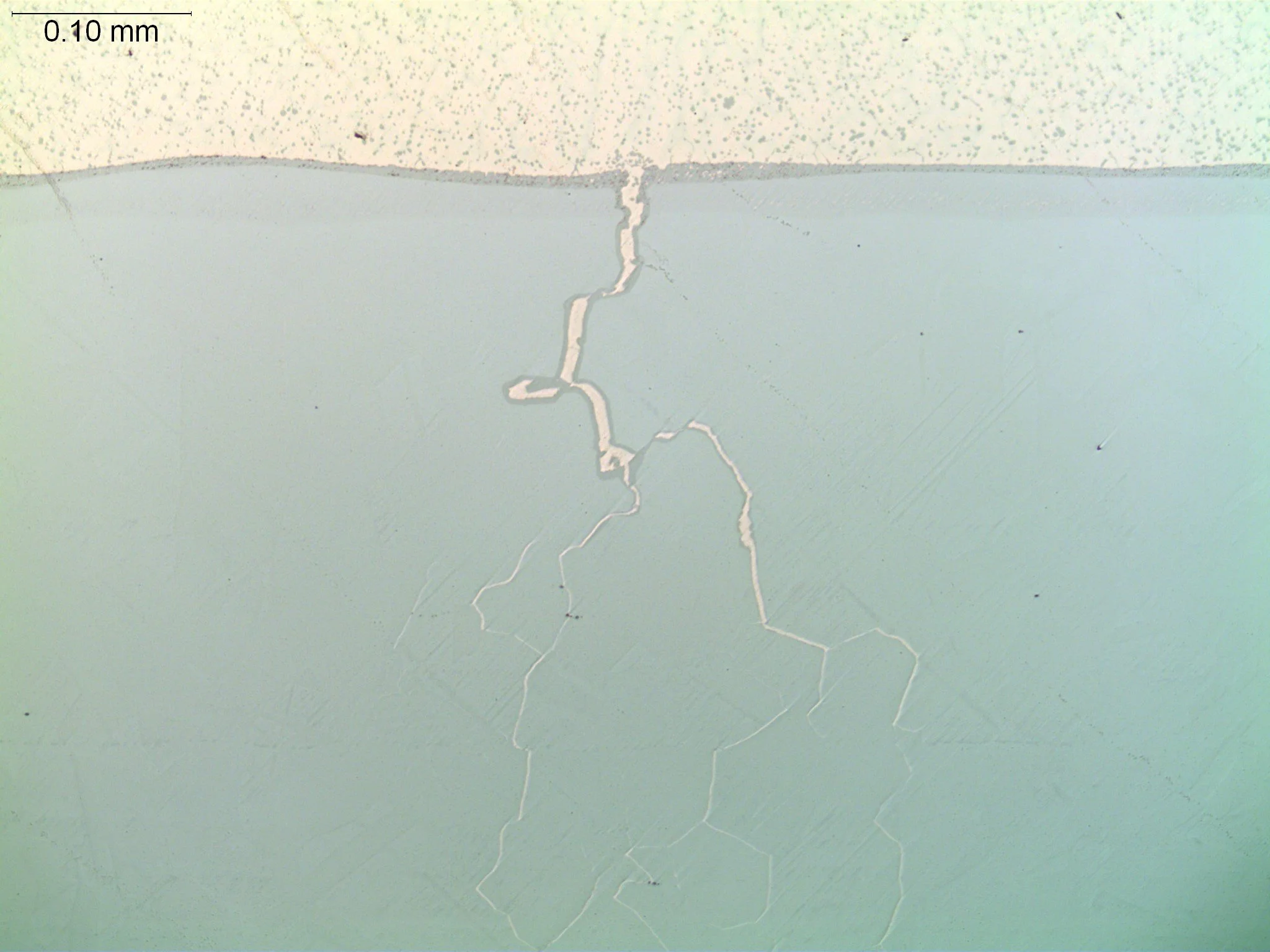 Liquid metal embrittlement (LME) crack branch, metallographic cross-sectional evaluation identifying branched intergranular fracture paths, molten filler metal penetration network, and alloy grain boundary cracking propagation per ASTM E3 under ISO 1