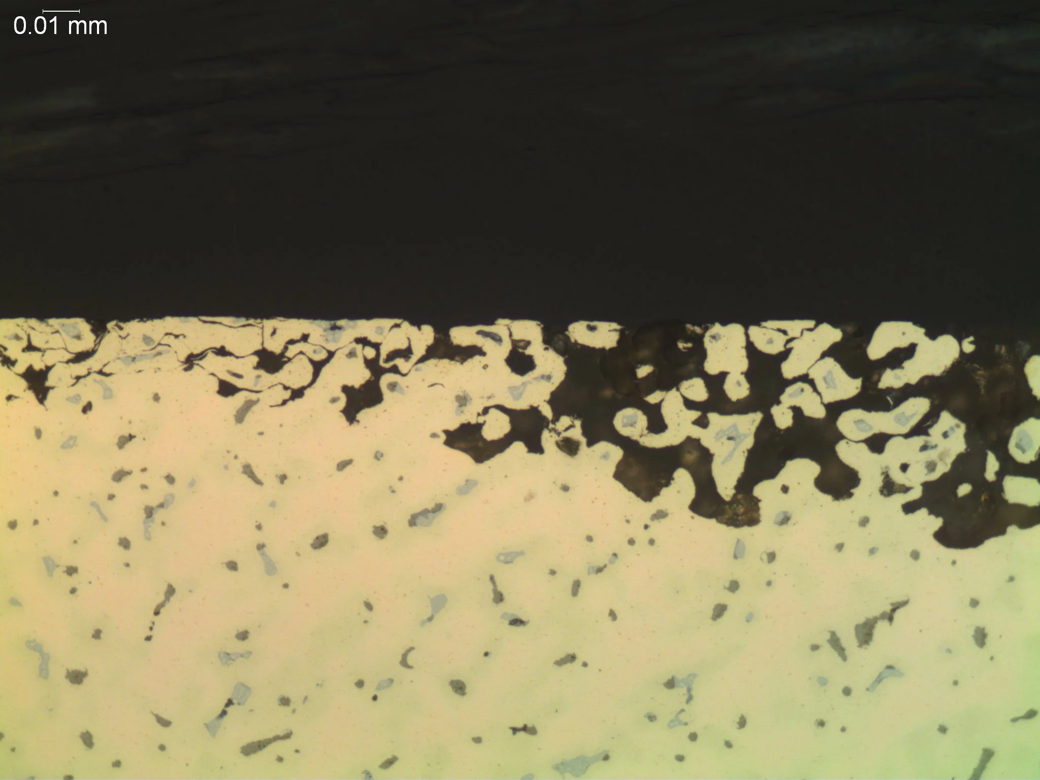 Corrosion of bronze 500x, metallographic cross-sectional evaluation identifying localized dealloying, selective element leaching, and a porous copper-rich oxide network penetration zone per ASTM G112 and ASTM E3 under ISO 17025 accredited laboratory 