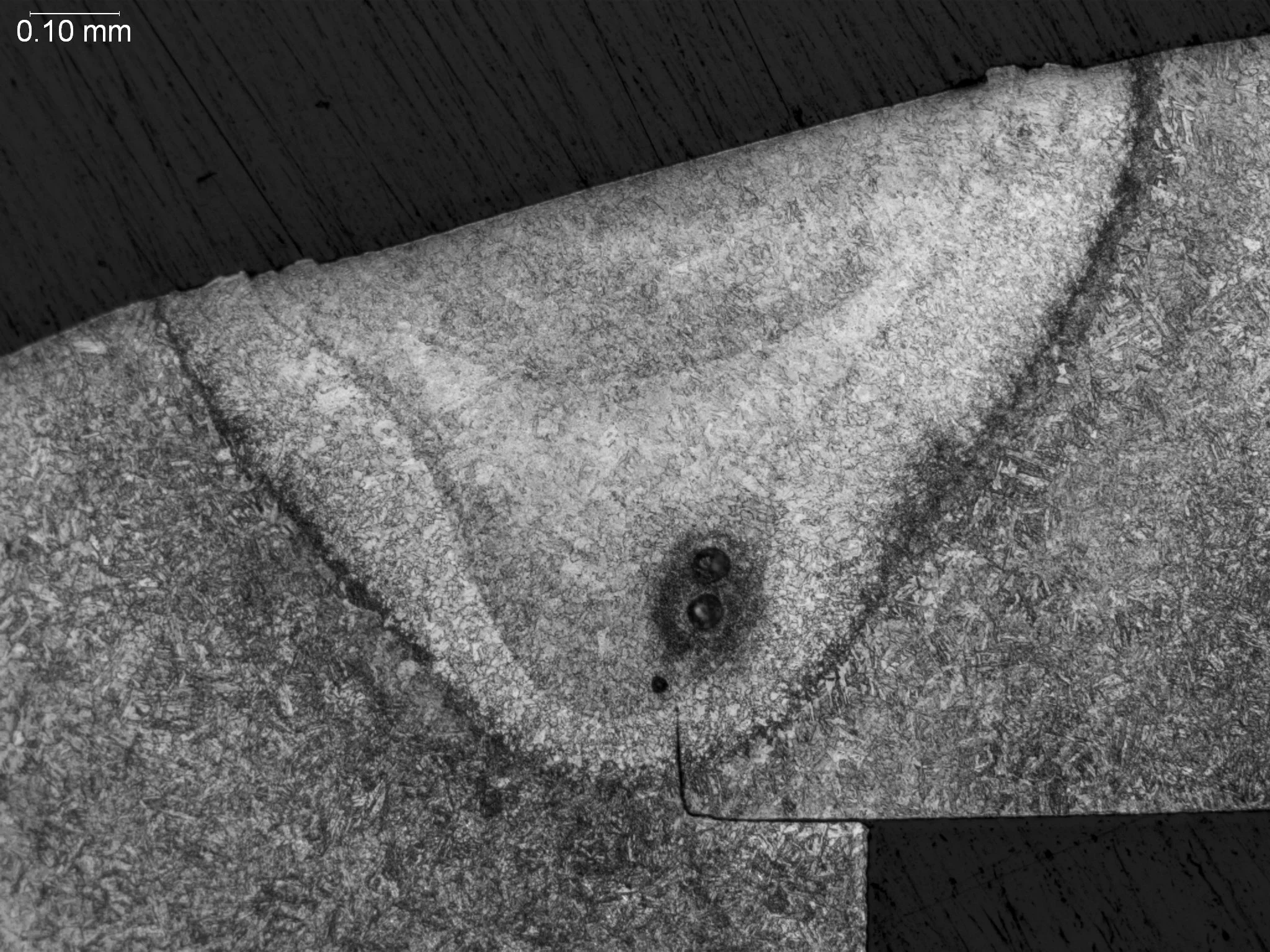 Weld fusion zone with gas porosity, macro-etch cross-sectional evaluation identifying spherical gas porosity defects near the root, a distinct heat-affected zone HAZ, and weld profile fusion line geometry per AWS D17.1 and ASTM E340 under ISO 17025 a