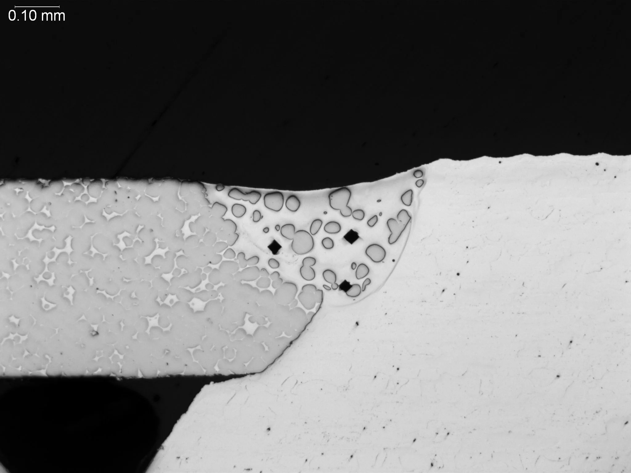Braze fillet microhardness testing and porosity, metallographic cross-sectional evaluation showing diamond microhardness indentations, gas porosity clusters, and dendritic phase distribution within a braze fillet pocket per ASTM E384 and ASTM E3 unde