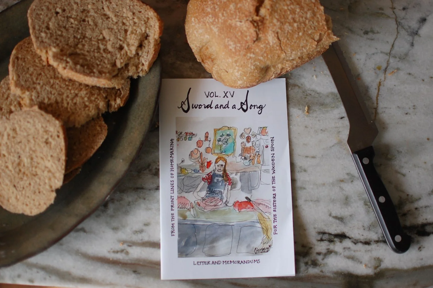 A newspaper titled 'Sword and a Song' lying on a marble countertop, with a large knife nearby, and slices of bread on a plate.
