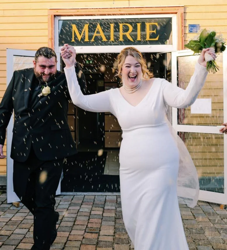 Newlywed couple celebrating outside the town hall in Saint Pierre and Miquelon after their wedding ceremony.