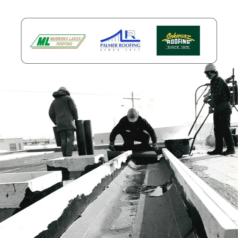 Construction workers installing a roof with roofing materials on a building.