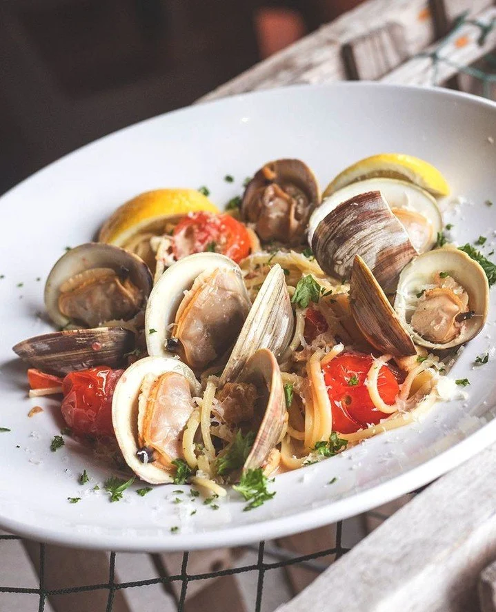 Grab a friend, order a glass of wine, and share a bowl of our GIO Linguine &amp; Clams. Whole littlenecks, chopped clams, cherry tomatoes, white wine, garlic, crushed red pepper, a touch of cream, scallions, and pecorino come together in a pasta that