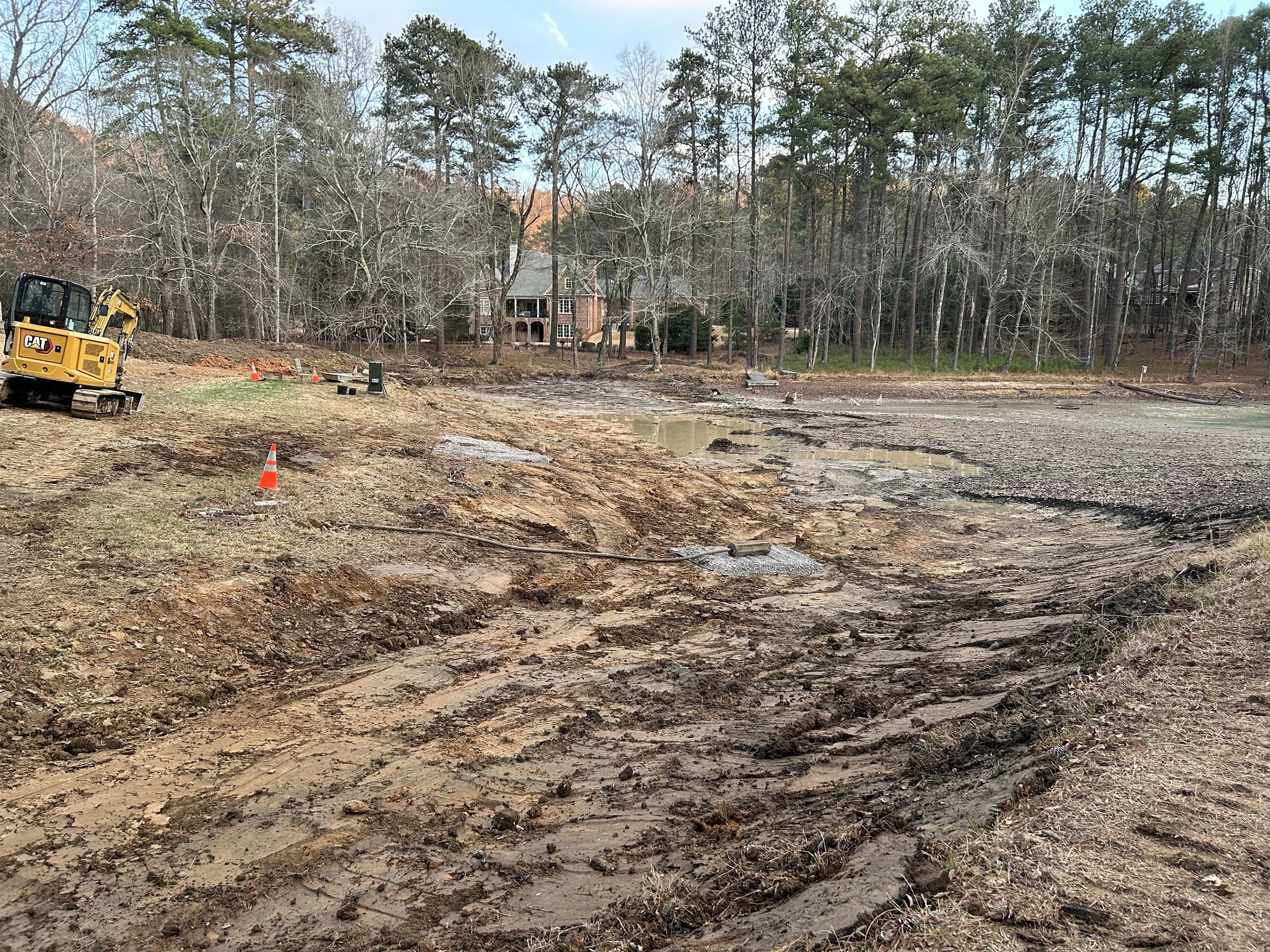 Pond after dredging showing the cleaned head section and defined ridge that limited sediment migration farther into the pond.