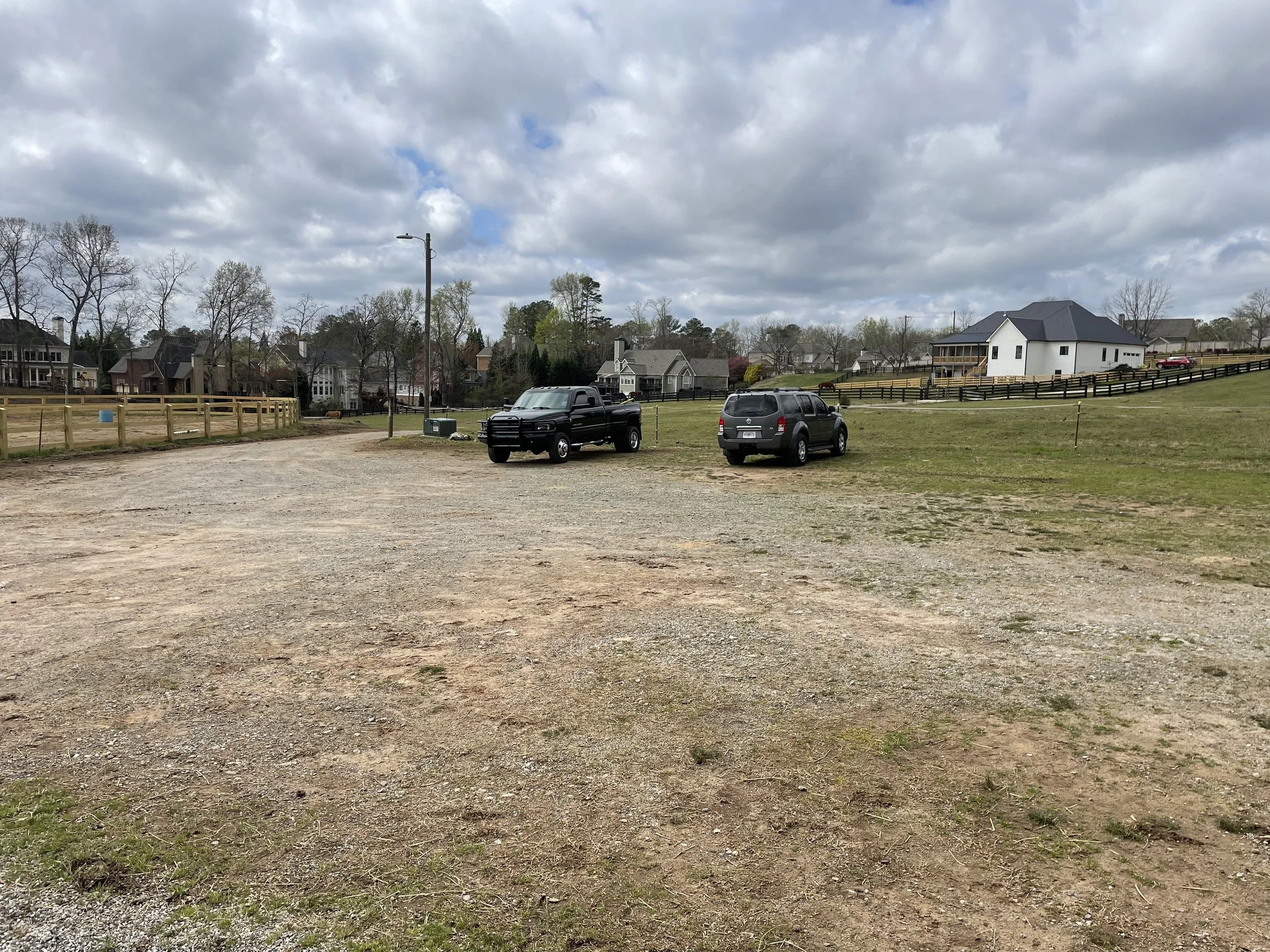 Existing sloped pasture and parking area before drainage and parking improvements in Marietta, GA