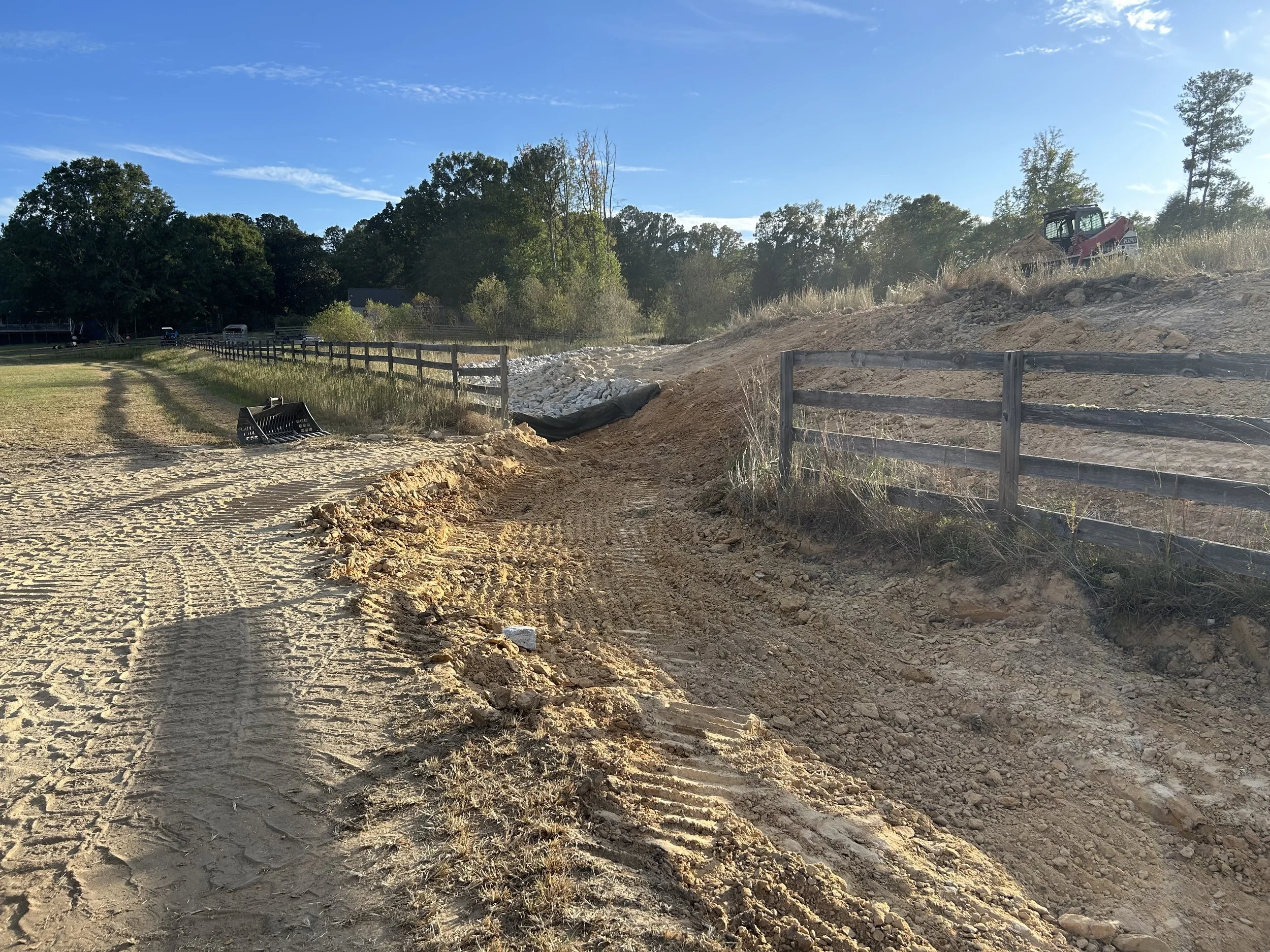 Excavated drainage channel during grade correction and preparation for rock lining on Fairburn farm