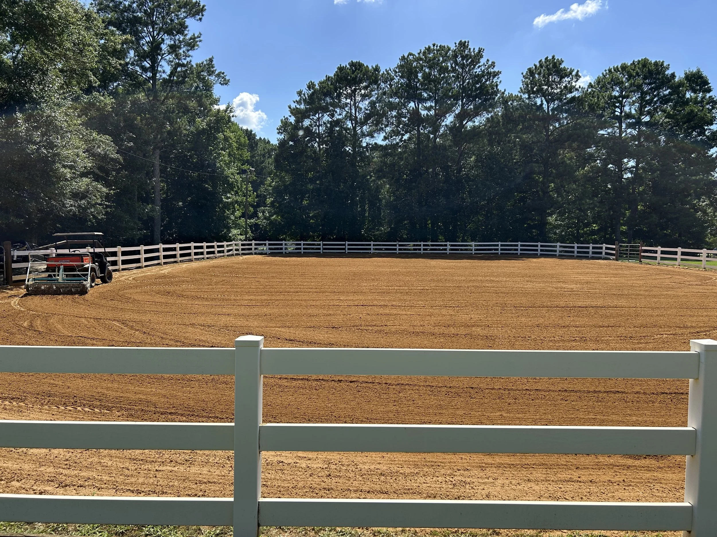 Outdoor arena surface being regraded during follow-up maintenance approximately 18 months later