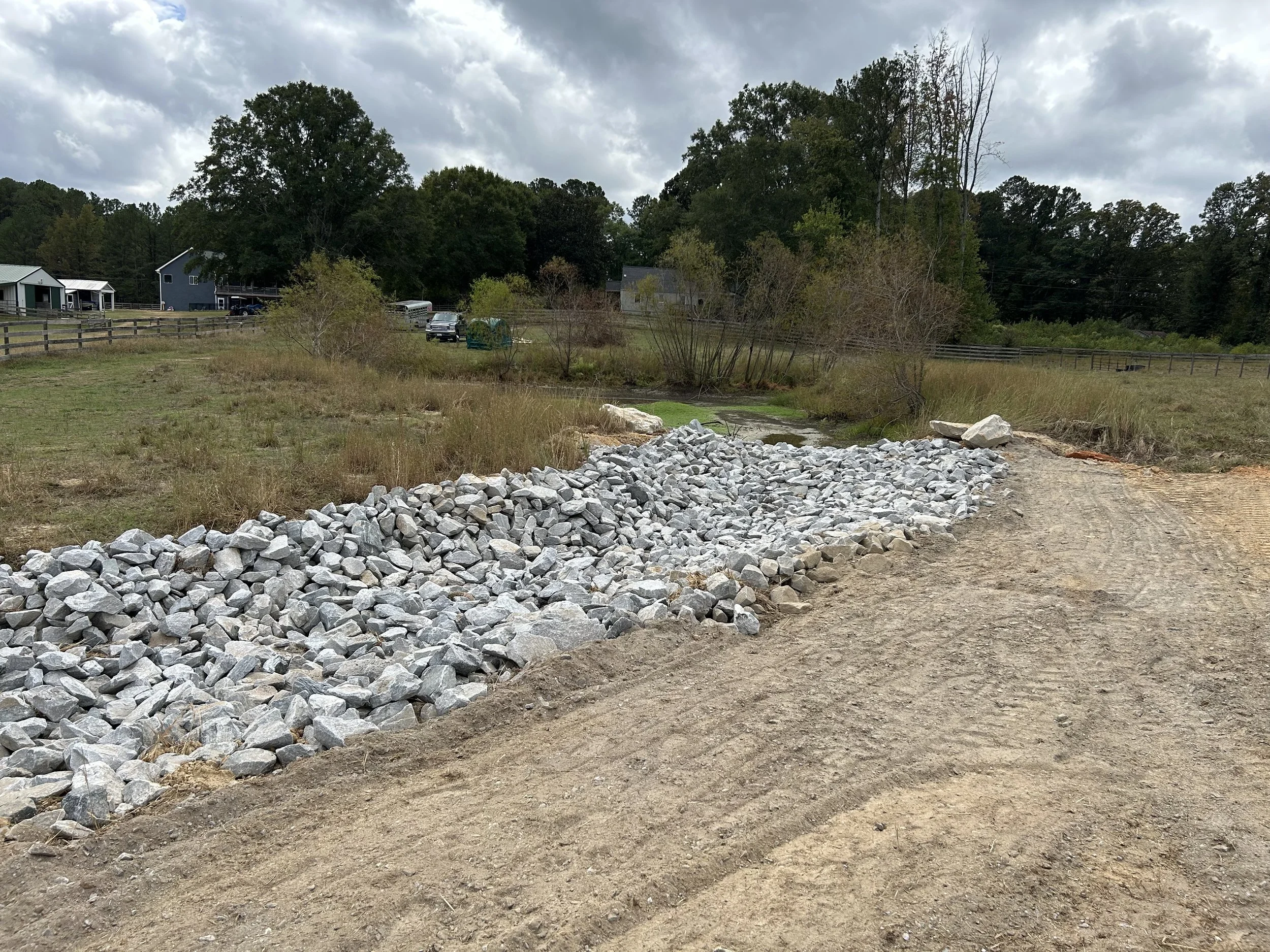 Completed riprap-lined drainage channel constructed to carry upper-pasture runoff through the Fairburn farm