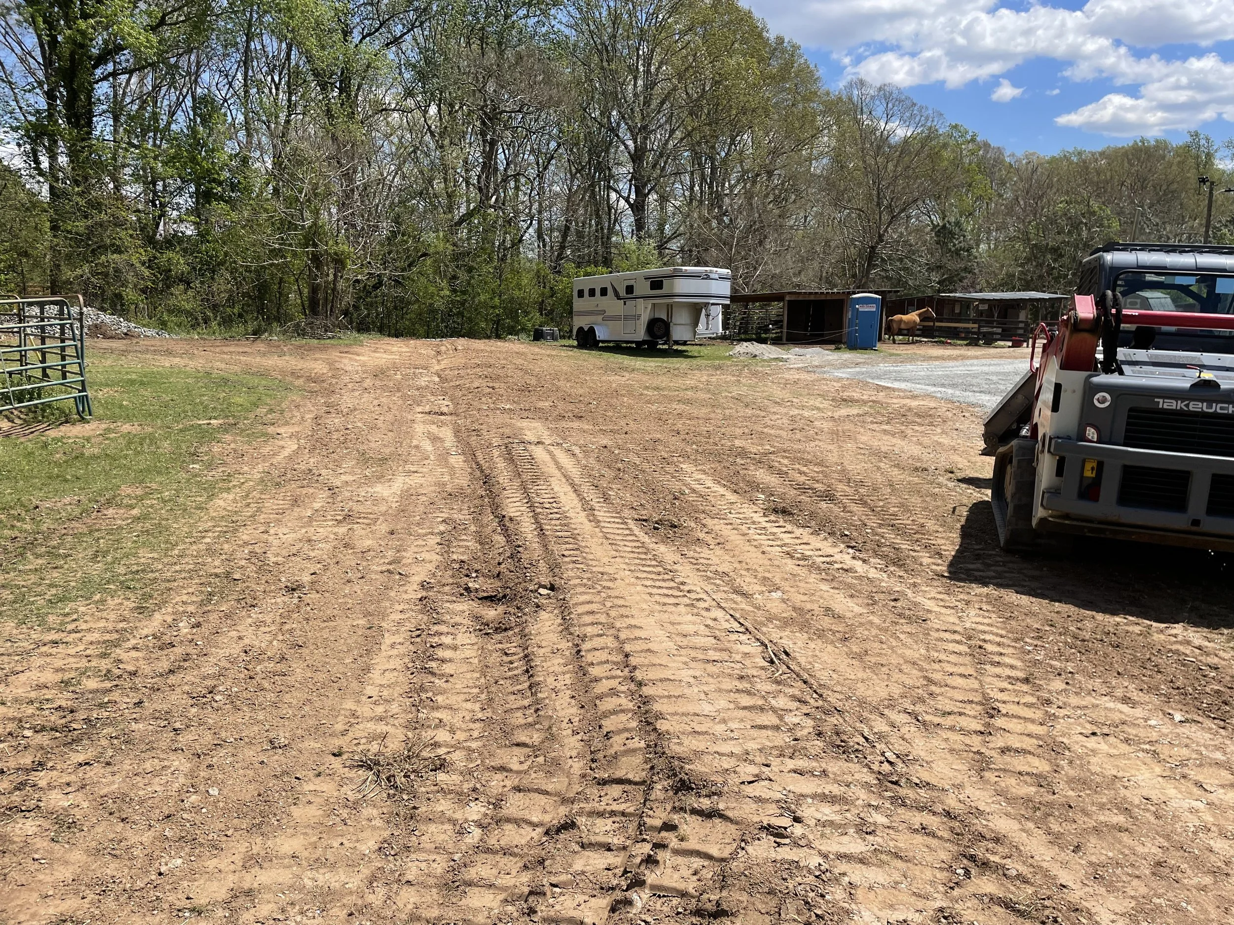 Diversion swale directing upper pasture runoff behind horse farm buildings in Marietta, GA