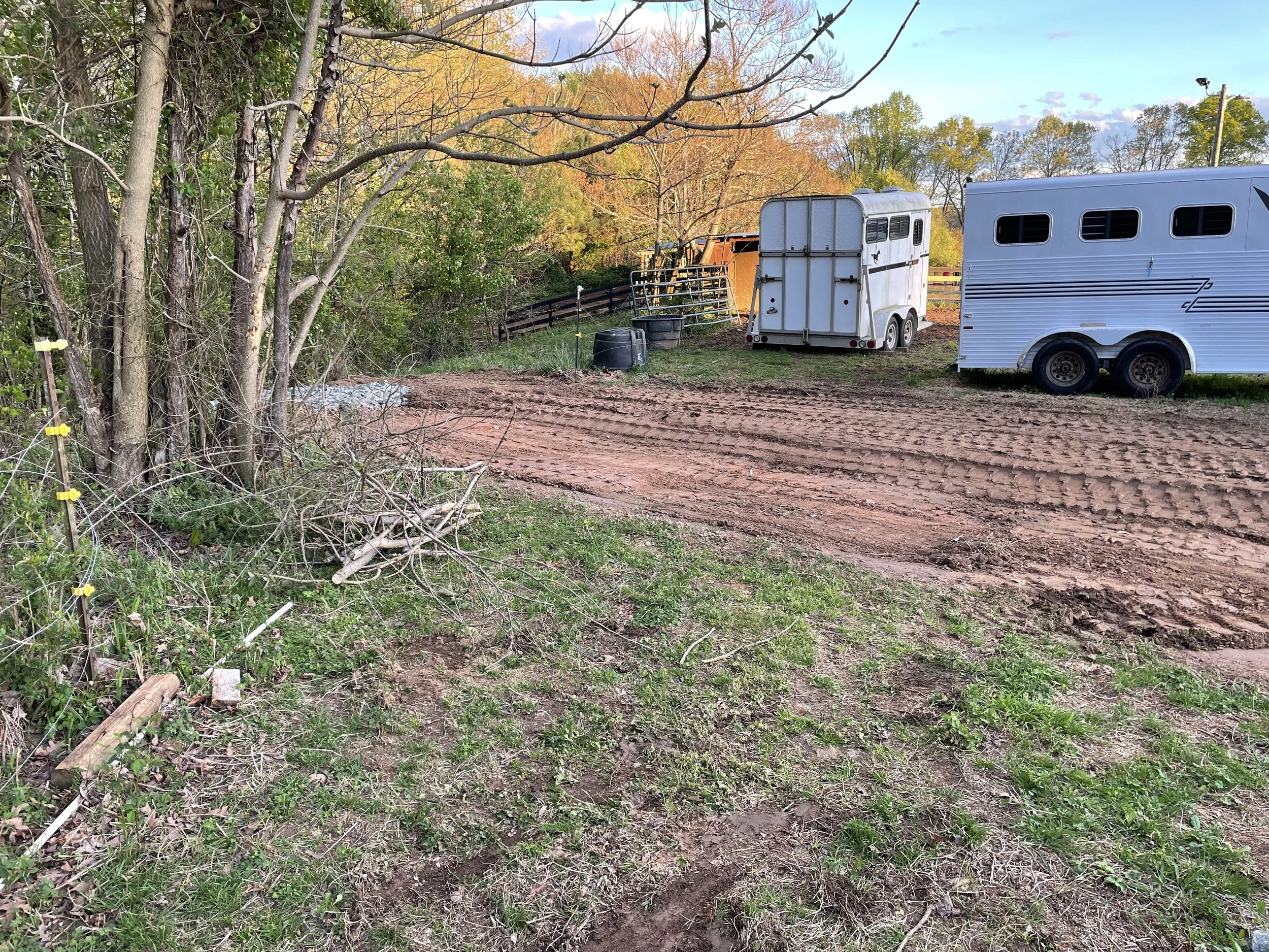 Rock-stabilized outlet carrying diverted pasture runoff downhill from horse farm parking area in Marietta, GA