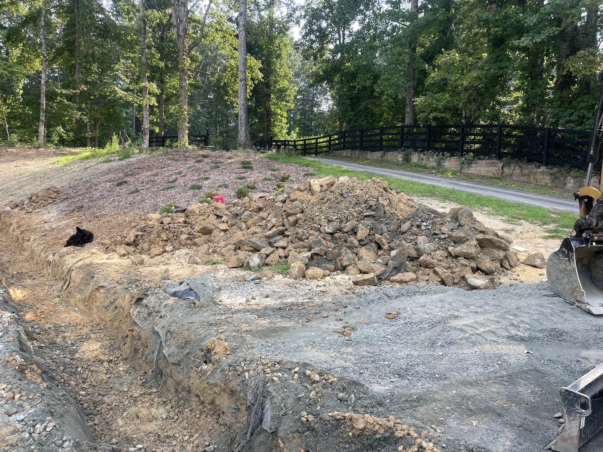 Riprap and sediment removed from the clogged farm perimeter drain during drainage rehabilitation.