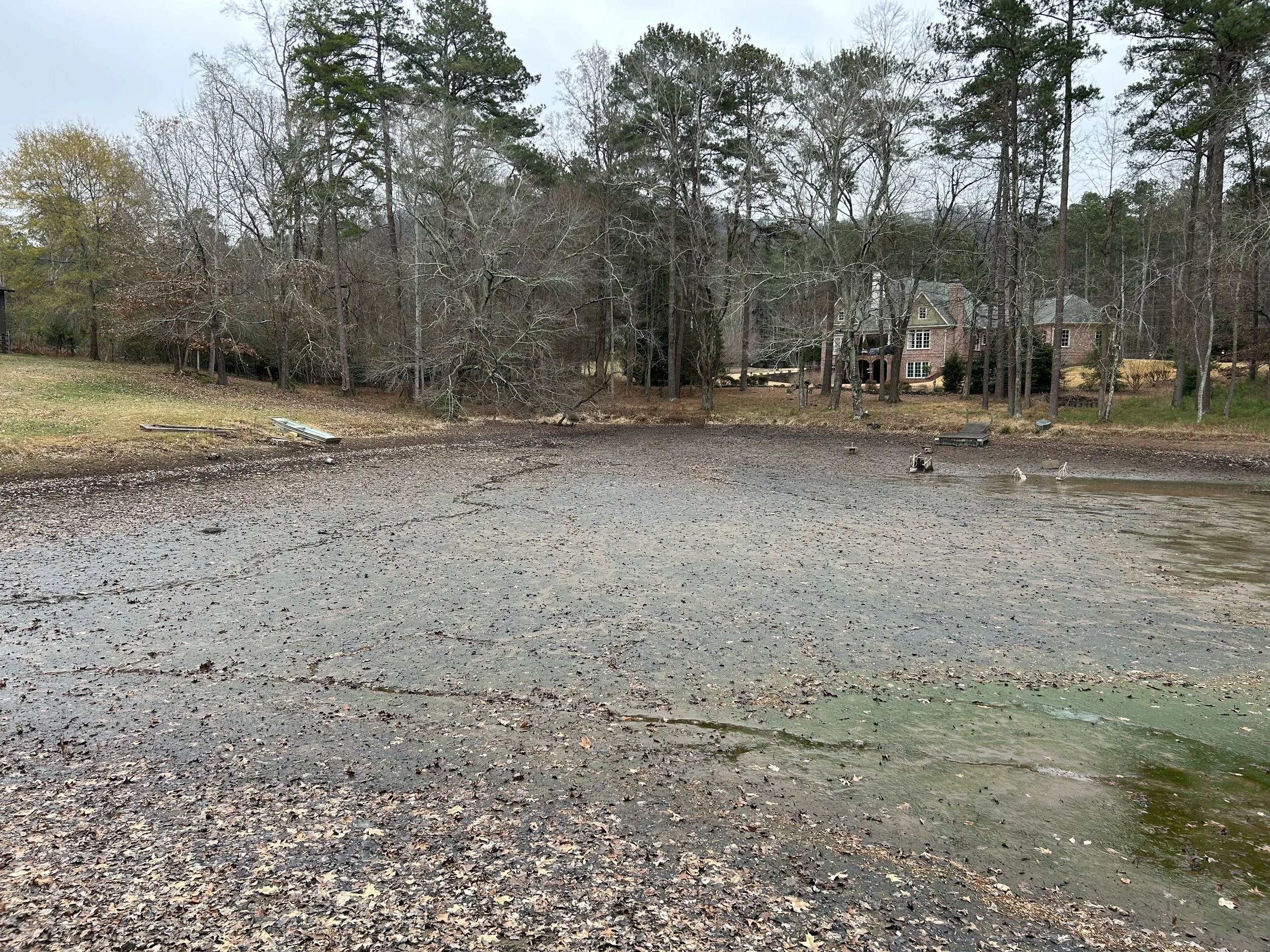 Kennesaw pond before dredging with accumulated sediment exposed after the water level was lowered.